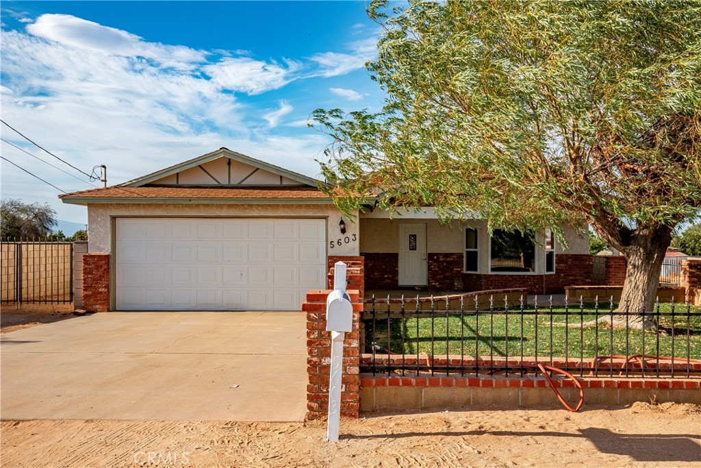 This charming ranch-style residence is a hidden gem. Custom-built with three bedrooms and two bathrooms, it sits on 0.96 acres of usable land and is situated on a semi-private road. The property offers direct access to Avenue M. The property's curb appeal is enhanced by a well-manicured lawn and a mature shade tree. The finished touch of hardscape, featuring brick columns and wrought iron fencing, along with the inviting front porch, provides an ideal setting to greet guests or immerse oneself in nature's tranquility. Upon entering the home, one is greeted by the custom characteristics throughout. The family room boasts a bay window, a brick fireplace ideal for chilly evenings, and a built-in hutch crafted from Oak. The kitchen offers ample space with multiple cabinets, stainless steel appliances, and an eat-in bar island. A spacious dining room provides room for both daily dining and entertaining guests. Three spacious bedrooms are situated along the hallway, including a primary bedroom and a guest bathroom. The primary bedroom features an additional fireplace. The primary bathroom offers a garden tub and a standalone shower. Step outside to enjoy features of a fully covered patio and an exterior block wall with the opportunity to create your own private oasis. Beyond the block wall lies the remaining acreage with back access to Avenue M. This home is conveniently located within walking distance of the charming town of Quartz Hill, which offers a diverse range of restaurants, shopping establishments, and other amenities. The local George Lane Park provides a public pool, baseball fields, a playground, and a skate park. Additionally, within walking distance are multiple elementary schools, a middle school, and a high school. This home is a must-see to appreciate its unique charm and features.