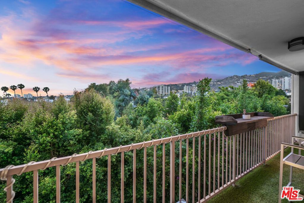 Elevate your lifestyle in this elegant top-floor condominium bathed in natural light and offering sweeping, panoramic views of West Hollywood, Beverly Hills, and the Hollywood Hills. This sophisticated residence boasts an expansive open-concept floor plan, where the spacious living room with a sleek fireplace and modern recessed lighting flows seamlessly to an oversized dining areaperfect for stylish entertaining. Floor-to-ceiling sliding glass doors open to a covered balcony, creating an effortless indoor-outdoor living experience. The well-appointed kitchen features new stainless steel appliances, generous cabinetry, and a charming walk-in pantry, offering both function and finesse. Retreat to the serene primary suite, complete with a luxurious en-suite bathroom featuring a beautifully upgraded double vanity and a custom walk-in closet with built-in organizers. A second renovated bathroom and a spacious guest room provide ample space and comfort with a walk-in closet. Additional highlights include central HVAC, in-unit laundry, and two dedicated parking spaces. Residents enjoy access to resort-style amenities, including a sparkling pool, sun deck, and stylish clubhouse. The unit also includes 2 tandem parking spots and a storage space in the garage. Ideally situated in the heart of West Hollywood, this chic condo is just steps from the city's most iconic dining, shopping, and nightlife. Moments from Cedars-Sinai, the Sunset Strip, and the Pacific Design Center, this is Westside living at its finest.