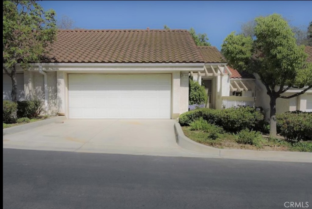 Nestled in the scenic hillsides of Camarillo, 2590 Antonio Drive is a beautifully updated dual-master townhome that blends comfort, convenience, and community living. Offering 1,712 square feet of living space, this residence features fresh paint, new carpet, hardwood and luxury vinyl plank flooring throughout, recessed lighting, central A/C and heating, and modern upgrades including a microwave and upgraded disposal. The inviting layout includes spacious dual master suites, a private patio off the kitchen, and a marble fireplace that adds warmth and character. The finished two-car garage has been drywalled and includes a work bench, shop light fixtures, and oversized storage cabinets, along with a two-car driveway for added convenience. Residents of the Vista Camarillo community enjoy resort-style amenities such as a pool, spa, jacuzzi, clubhouse, tennis courts, basketball court, pickleball courts, and lush greenbelts shaded by mature trees. RV parking with clean out. The neighborhood is pet-friendly with convenient doggy stations and surrounded by native flora and fauna, creating a vibrant and welcoming environment. Ideally located near the police station, hospital, library, shopping, dining, and excellent schools, this property offers the perfect balance of modern living and community lifestyle.