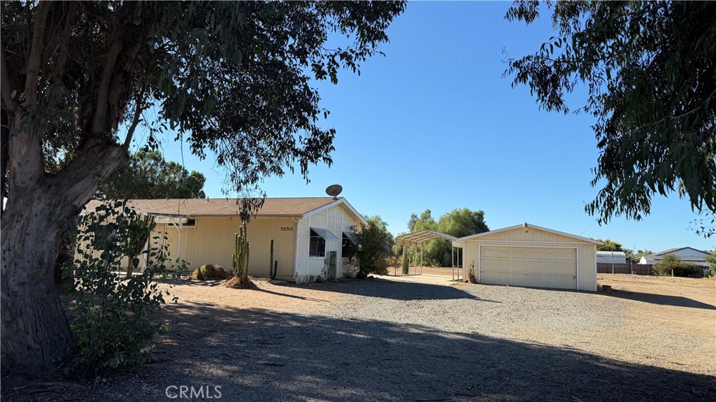 Low Inventory and Hard to Find, 2.5 Acres with Room to Roam. This 1983 manufactured home offers 1,440 sq. ft. with an open floor plan, 3 bedrooms, and 2 bathrooms. A large concrete patio off the back provides outdoor living space, and the oversized detached garage allows for parking, storage, or workshop use. Set on 2.5 flat, fully fenced acres in a prime Winchester location, this property is ideal for a variety of uses. Plenty of room for RVs, trailers, or additional outbuildings, and the acreage offers potential for animals, gardens, or future improvements. Conveniently located near major roads and area amenities while still providing space and privacy.