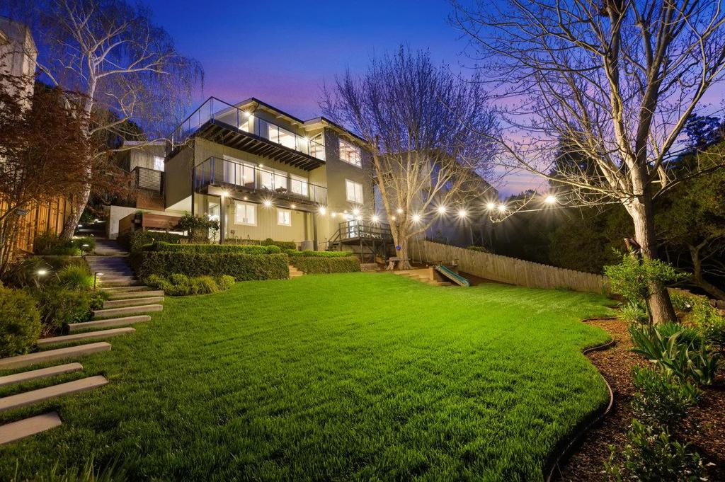 Welcome to this stunning home blending luxury, comfort, and modern convenience. Nestled on nearly half an acre, this updated 5-bed, 4-bath residence offers 3,645 sq. ft. of beautifully designed living space. The upper-level living area boasts unobstructed San Francisco views, while the property cascades to a flat backyard with a serene grove of oak trees. From the moment you arrive, you'll appreciate the thoughtful upgrades and exquisite craftsmanship. Natural light fills the open-concept spaces, complemented by two fireplaces. Modern ipe decks and bi-fold doors seamlessly connect indoor and outdoor living, perfect for entertaining. A movie room, temperature-controlled wine room, and billiards table enhance this entertainers dream. The chefs kitchen features a Sub-Zero fridge, wine fridge, 36 Wolf 6-burner range, Bosch appliances, Ventahood, and custom cabinetry. The expansive backyard offers oak trees, a zip line, swing set, slide, sandbox, Ipe decks, gas fire pits, and a waterfall feature. A fully updated in-law unit with a private entrance, kitchen, bath, and laundry adds versatility. Additional highlights: three-zone climate control, Ethernet wiring, 220V EV charger, Tesla solar (paid), and upgraded electrical. A rare gem offering luxury, convenience, and breathtaking views!