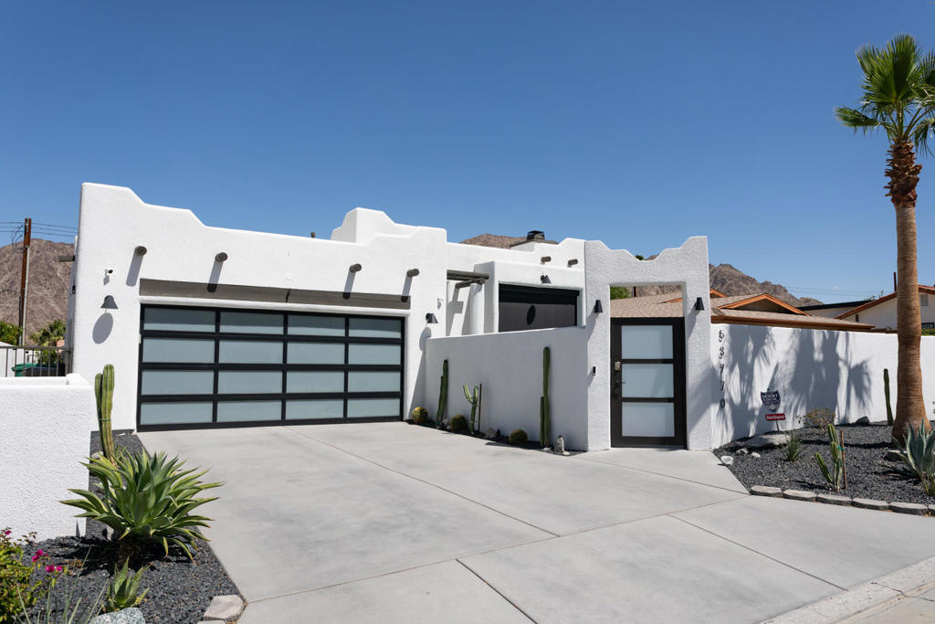 Santa Fe meets modern in this highly upgraded cove home. You will not have any headaches, upgrades or remodels in your near future. Everything has been impeccable restored. Enter the home thru a charming enclosed courtyard with your own private pool. The backyard outdoor space has a new spa to sit in while taking in the mountain views. The landscaping has been updated to included synthetic grass , low maintenance bushes and new concrete with drainage system. French doors open to give the living areas good indoor outdoor flow to the outdoor entertaining and relaxing areas. The front living room is equipped with a fireplace to keep you warm during a chilly desert winter eve. Nothing has been overlooked in the remodel of this single level pool home using all high end appliances and finishes. Some of the upgrades include: New Miele Kitchen package, new flooring throughout, new energy efficient windows, new lighting, ceiling fans and Newport brass faucet fixtures. New paint indoor and outdoor. The pool and pool equipment have been all redone to enhance your swim in your new salt water pool! A Sonos speaker system with voice recognition is in the home and everything in the home is able to be run off apps. The home is secured with a 360 degree camera security system for added features and protection. There is an on demand instant hot water system and a newer ac. The garage has not even been overlooked with a side mounted garage door opener to open your new door into a garage cooled by AC. Book your showing today so you don't miss out on this awesome home!