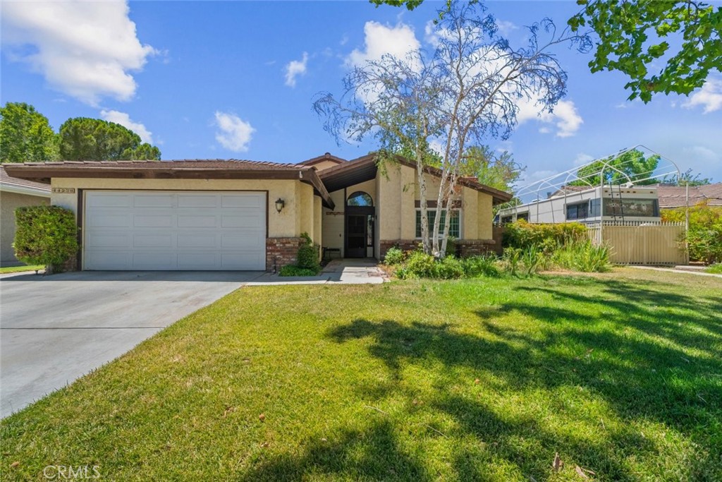WOW ENTERTAINER'S BACKYARD BACKYARD BACKYARD! Dont miss out on this home representing the true meaning of pride of homeownership! Located in the heart of Lancaster this beautifully well maintained single-story home features 3 bedrooms, 2 bathrooms with a PARK LIKE BACKYARD AND SOLAR PANELS. This inviting residence offers a bright and open layout with vaulted ceilings, large dual-pane windows, and an abundance of natural light throughout. The cozy living room with a fireplace, separate dining area, and thoughtfully designed kitchen with newer quartz countertops, updated blinds, and plenty of cabinetry make this home ideal for everyday living and entertaining. The oversized primary suite includes an en-suite bathroom and overlooks a beautifully landscaped backyard with mature trees, perfect for relaxing or hosting summer gatherings. Enjoy the outdoors under the covered patio in your private entertainer's yard. Additional highlights include affordable solar panels, an attached 2-car garage, and no HOA or Mello Roos. Situated in a well-kept neighborhood close to freeways, schools, shopping centers, Antelope Valley College, parks, restaurants, and Cinemark Lancaster, this home offers the perfect blend of comfort, convenience, and style.