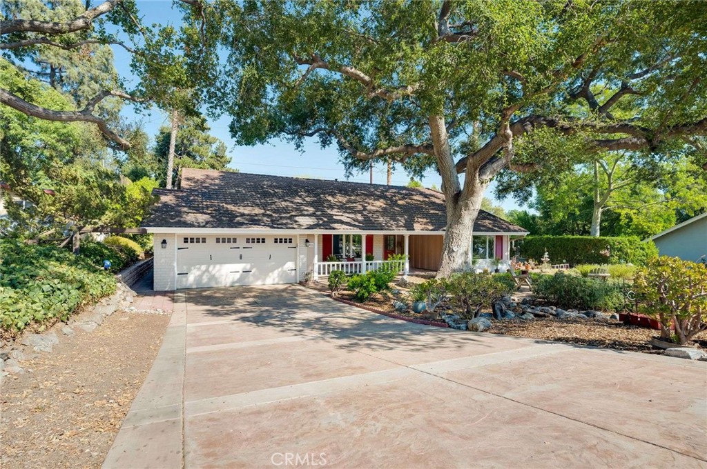 Tucked along the quiet greens of San Dimas Canyon Golf Course, and minutes from the Equestrian Center, this charming, well-loved home isn’t just a place to live—it’s a retreat from the noise of the world. Perched on a generous lot where the neighborhood gently meets nature, this home offers something rare: peace, space, and a sense of belonging.
Step onto the welcoming front porch, where golden-hour sunsets paint the sky and evening breezes invite you to sit a little longer. Inside, an open and spacious entry gives way to a large, flexible front room—once a formal living room, now ready to become anything you need: a play space, home office, or even a guest suite.
To the right, the heart of the home begins with an updated kitchen featuring a Dining nook, Corian countertops, refinished cabinets, and a newer stovetop—ready for slow Sunday breakfasts or lively dinner parties. The space flows easily into a formal dining area and cozy family room centered around a wood-burning fireplace, where warmth and conversation naturally gather. Off to the side, a bright enclosed sunroom brings the outdoors in, perfect for morning coffee or afternoon reading.
Down the hall, discover two inviting bedrooms and the master suite. Two full bathrooms serve the space; one has already been tastefully remodeled, while the other is a blank canvas, ready for your personal touch.
But what truly sets this home apart are the thoughtful upgrades that ensure comfort for years to come: a lifetime metal roof for fire safety, newer AC and heating systems, copper plumbing throughout, a brand-new sewer line, newer engineered wood floors, a new water heater, a new driveway and Double Paned windows throughout.
Step outside and let the view take your breath away. The backyard opens to a panoramic view of the golf course and the mountains, framed by drought-tolerant landscaping and an orchard-like collection of fruit trees—Apple, Tangelo, Orange, Kumquat, Lime, Grapefruit and Myer Lemon—all thriving on an efficient drip system. It’s a gardener’s delight, a family’s playground, and a quiet sanctuary all in one!
