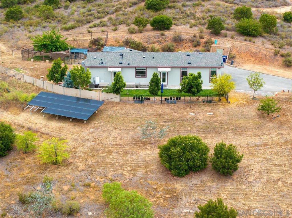 Country Charmer. Huge views from this 2.62 acre perched overlooking the valley. This manufactured home was built in 2022. It offers 3 beds, 2 baths and is 1728 square feet. The layout is open and the ambient light is great thanks to tons of windows and high ceilings. Kitchen has tons of counter and cabinet space and a large walk in pantry. Primary suite offers a large walk-in closet and en suite bathroom with a step-in shower. There is a 10x10 bunker built into the hill adjacent to the home that is a great spot for storage. Solar and Tesla Powerwall. Fenced yard. Air conditioning.