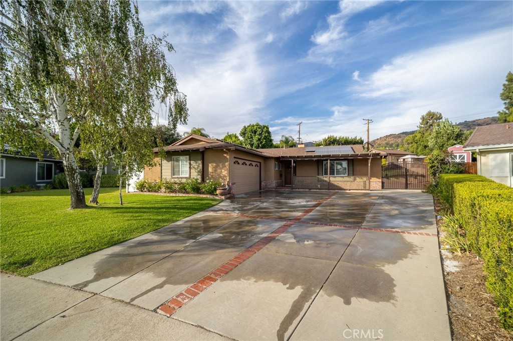 Welcome to 618 Thornhurst! The front house offers 3 bedrooms and 2 bathrooms, while the back house provides 1 bedroom and 1 bathroom, making this a rare Glendora property with two homes on one expansive lot at the end of a peaceful cul-de-sac that feels like a private corner lot. The main residence includes a primary suite with attached bath, a spacious living room with a brick fireplace, a beautifully upgraded kitchen with granite counters, custom cabinetry, and stainless steel appliances, plus a dining area, family room, and a bright sunroom/den for added living space. The back home features its own full kitchen, living room, and modern finishes—ideal for extended family, in-laws, or rental income. Each home enjoys separated yard spaces for privacy, while shared outdoor amenities include a sparkling pool, large grassy lawn, covered patio, and mature landscaping. Additional highlights are solar panels for energy efficiency, ample parking, and a desirable location near Willowsprings Park and top-rated Glendora schools. This property offers versatile living options, resort-style outdoor amenities, and an excellent opportunity for multi-generational living or investment.