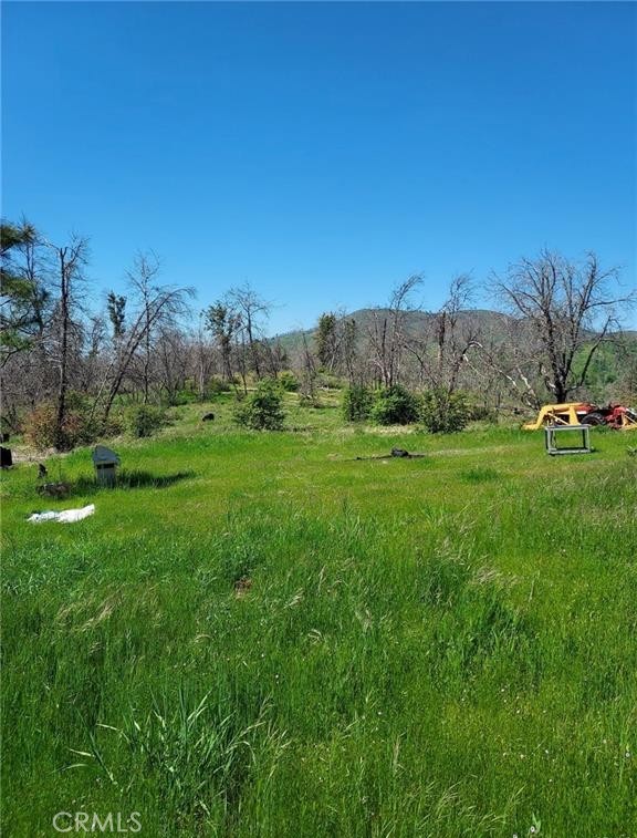 Just under 10 useable acres in the Jerseydale area. Had a gorgeous home until the Oak fire. Has 2 wells and septic which are working and have been inspected post fire. All new electric and PGE installed new underground electric cables to the area. 30'-40' carport with two 9' high-8' long storage container which feature rollup doors. new reinforced concrete floor. Working tractor included. Corners are marked. New owned solar panels which need inverter and batteries. steel water 3,000 gallon water tank with new pump. Storage shed. Gated driveway. Has a pad and easy hookups for a trailer to be in place while you build your dream home or just for a getaway. Electric box equipped for 50 amp service. A beautiful parcel in a beautiful mountain area.