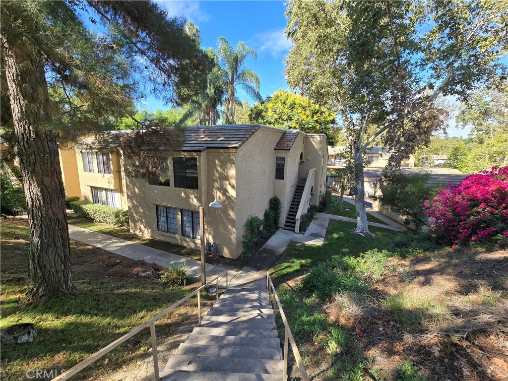 CANYON CREST CONDO - Welcome to this beautiful second-floor condo located in the highly desirable Canyon Crest community! As you step inside, you’ll be greeted by a warm and inviting living room featuring a cozy fireplace—the perfect place to relax after a long day. Just off the living area, a private balcony offers serene views of the sparkling pool and mature trees. From the living room the spacious dining area flows seamlessly into the kitchen, which has lots of storage. This home features three bedrooms and two bathrooms, including a large primary suite with its own en suite bathroom and walk-in closet. The two additional bedrooms share a full bathroom. The unit includes one garage space. The community offers resort-style living with beautifully landscaped grounds, a refreshing swimming pool, and convenient on-site laundry facilities. With its prime location near shopping, dining, schools, and easy freeway access, this condo combines comfort, convenience, and charm.