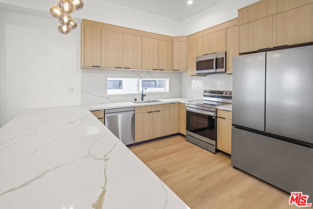 ** PET FRIENDLY ** PRIVATE ROOFTOP DECKS ** 2-CAR PRIVATE GARAGE ** WASHER/DRYER ** CENTRAL A/C ** KITCHEN ISLAND ** PRIVATE YARD ** Welcome to Hortense Townhomes, a brand-new luxury residence in the heart of North Hollywood offering high-end finishes, spacious interiors, and unbeatable amenities. These thoughtfully designed units feature expansive living rooms, oversized bedrooms, and open-concept layouts perfect for modern living. The chef's kitchen boasts a large island, beautiful stainless steel appliances, quartz countertops, and custom cabinetry. Each unit includes an in-unit washer and dryer, central A/C and heat, recessed lighting, and premium flooring throughout. Enjoy your own private garage plus an assigned parking space for added convenience. The building is pet-friendly and offers an incredible shared rooftop deck with sweeping city views for relaxing, entertaining, or working from home in style. Located on a quiet residential street yet minutes from the vibrant NoHo Arts District, Toluca Lake, studios, shops, restaurants, and transit. This is elevated urban living at its finest. Don't miss your opportunity to call it home! **
