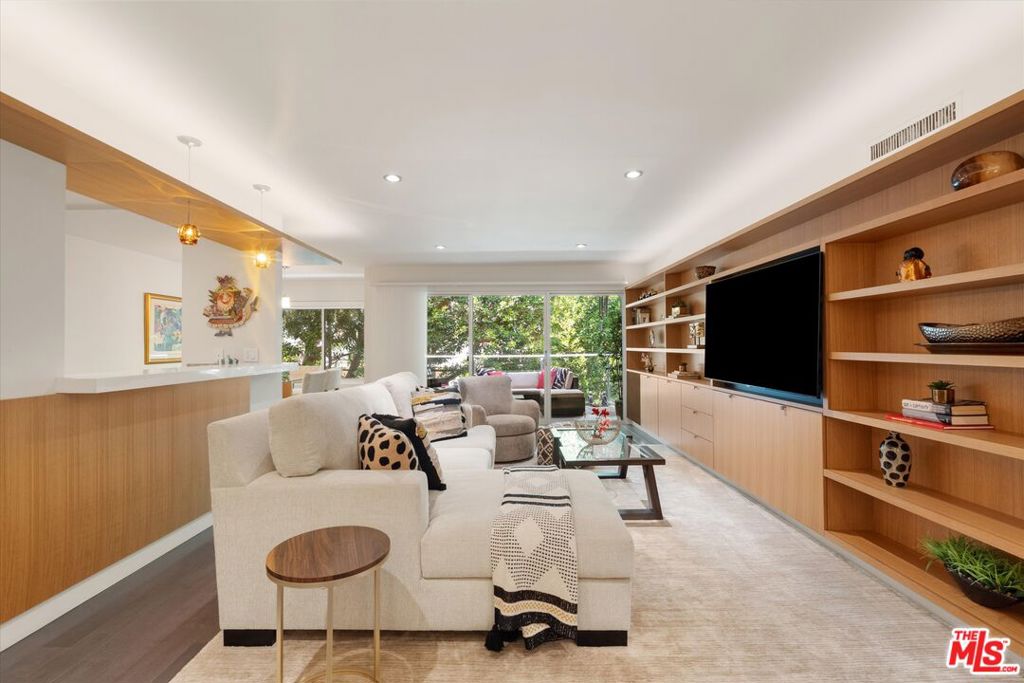 Tucked away on a quiet Brentwood cul-de-sac, this top floor corner unit at Chenault Flats offers privacy, style, and seamless indoor-outdoor living. With only one shared wall, the two-bedroom two-bathroom condo features floor to ceiling sliding doors that open to a private balcony with treetop views, an open kitchen with Bosch appliances and quartz counters, a spacious primary suite with dual closets and en suite bath, in unit laundry, and engineered wood floors throughout. The boutique 22-unit building includes a pool, fitness center, and gated side by side parking, all just moments from San Vicente's shops, cafes, and Whole Foods.