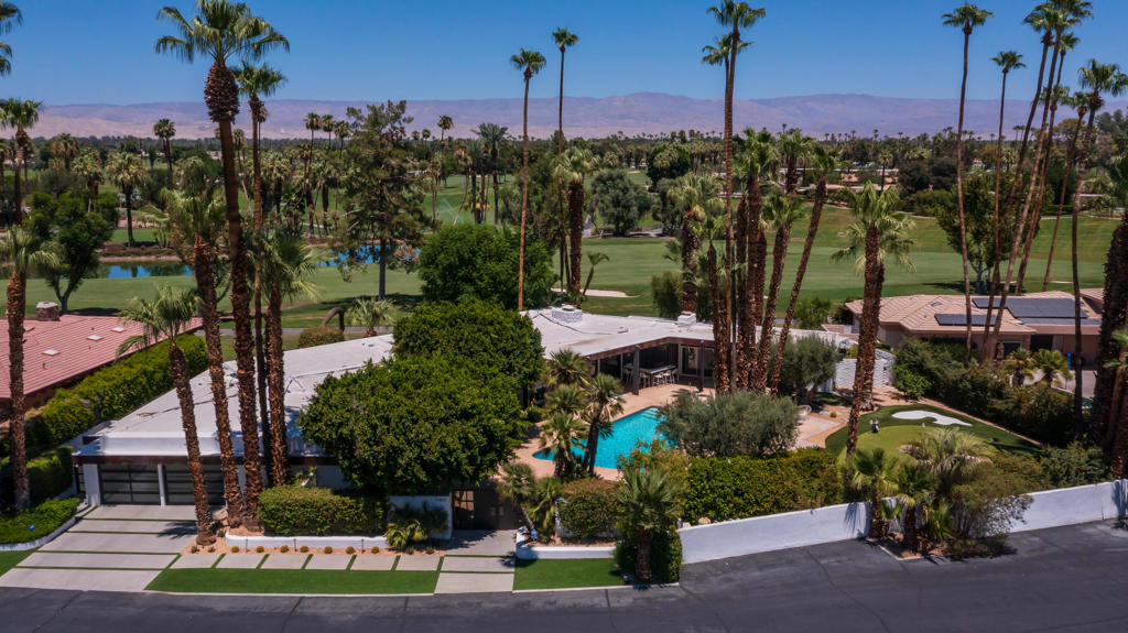 Set on the 9th Fairway of the legendary Thunderbird Country Club in Rancho Mirage, this extraordinary residence combines architectural pedigree with modern luxury. Originally designed by renowned architect William Cody, the home was fully reimagined in 2018 with a comprehensive remodel that preserved its timeless mid-century character while introducing contemporary elegance.Offering 4+ bedrooms, 4,344 square feet including an attached casita with exterior entrances, and a versatile floor plan, the home is ideal for both intimate living and grand-scale entertaining. Expansive walls of glass capture breathtaking mountain and fairway views, blurring the line between indoors and out. The open-concept living spaces are anchored by sleek finishes and abundant natural light, creating a sense of warmth and refinement throughout.The entry courtyard has a pool/spa and covered patio area that includes a built-in bar with BBQ, plenty of space for outdoor living and dining, and a putting green and sand bunker. Two luxurious primary bedroom suites provide comfort and privacy, while the updated bathrooms reflect modern design and sophistication.Outdoors, multiple terraces, the pool and lounge areas invite relaxation against the backdrop of Thunderbird's lush fairways and dramatic desert mountains. This is an exceptionally rare opportunity to own a Cody-designed home within one of the Coachella Valley's most prestigious and historic clubs, where architecture, lifestyle, and setting converge perfectly.
