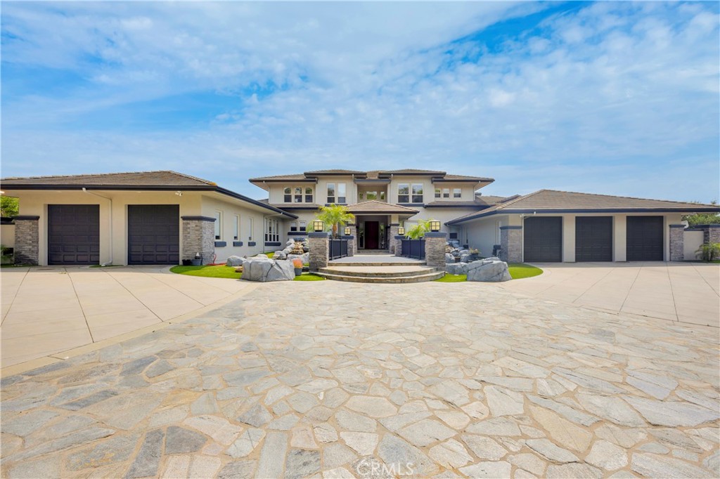 Situated behind your own private gate is an expansive 2.1 acre custom, and peaceful lot. The spacious back yard features a resort style salt water pool and spa, equipped with a swim up bar, water features, covered outdoor BBQ area, fireplace, and bar seating. Tune up your golf game! The yard is surrounded by Pitch n Put area and new putting greens. There is also a cross over bridge which will take you to a secondary covered seating area. The backyard and home have breathtaking views from almost any location. All this, along with the large grass area, make it the perfect escape from reality, and an entertainers dream home. The luxurious interior features 6 bedrooms, 6.5 bathrooms, and over 6,400 square feet. You are welcomed by high ceilings, a. double sided fireplace, and a rare main floor master suite with a fireplace, soaking tub, large walk in shower, wet bar, sitting room, patio, and direct access to both the backyard and garage. The oversized driveway with a 5 car garage is perfect for any car enthusiast, or large family. Ideally located in The Enclave Community of Coto De Caza, you are walking distance from all the community has to offer- including the Golf & Racquet Club, parks, walking trails, and much much more. Please do not wait and schedule a showing today- you will not want to miss this incredible opportunity.