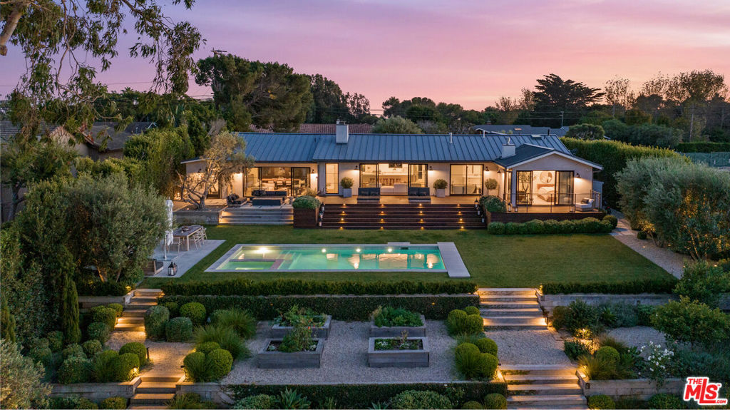 Exceptional Mid-Century Modern masterpiece offering a rare blend of classic design and modern luxury. Meticulously restored and remodeled, this gated and private circa 1957 architectural seamlessly marries iconic design elements with contemporary finishes, resulting in a residence that exudes timeless sophistication. Open-concept floorplan with effortless flow and expansive walls of glass lead to inspired canyon views over an acre of meticulously landscaped grounds. Primary suite sanctuary with fireplace and refined ensuite bath. Gourmet kitchen with custom cabinetry and top-of-the-line appliances. Sun-dappled dining room aerie. Private guest house bedroom retreat. Sun-soaked gym/Pilates studio with panoramic views transforms a workout into an elevated experience. Beautiful sparkling pool and spa with underground vault cover. Outdoor cold plunge and shower. Magical organic herb and vegetable garden set beneath the canopy of an epic Eucalyptus tree. Spacious decking with outdoor fireplace and BBQ for entertaining, dining al fresco, or hanging out under the stars. Vast green lawn for play. Sonos sound system. A rare, serene oasis with unparalleled amenities, comfort, privacy, and land on cherished Pt. Dume.