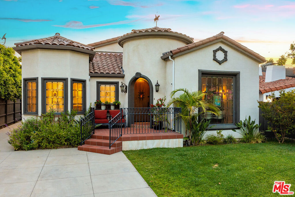 Welcome to 4359 Clybourn Avenue. South of Riverside. A distinguished residence that embodies the refined marriage of elegant Spanish Colonial Revival architecture and contemporary sophistication. Situated behind gates on one of Toluca Lake's most coveted, tree-lined streets. This private and impeccably updated estate features 4 bedrooms, 5 bathrooms, and 2,926 square feet of thoughtfully curated living spaceincluding a newly built two-story ADU and resort-style outdoor amenities. Step through the arched tower entry into a sun-drenched interior that seamlessly blends old-world charm with modern design. Rich hardwood floors, arched ceilings, and dramatic architectural detailing frame the home's inviting layout. The formal living room, anchored by a fireplace and handcrafted leaded glass windows, flows effortlessly into the coffered-ceiling chef's kitchencomplete with a honed marble island, Thermador appliances, pot filler, beverage bar, and cozy breakfast nook. The primary suite is a private retreat featuring an impressive custom wood pyramid ceiling, spacious walk-in closet, and a spa-like en suite with a freestanding tub, walk-in shower, and double vanities. Two additional bedrooms are connected by a beautifully appointed Jack-and-Jill bathroom. A fourth bedroom in the ADU with en suite bath offers ideal accommodations for guests or multigenerational living. Outside, the gated backyard oasis awaitscomplete with a sparkling pool, above-ground spa, multiple patios, and lush landscaping designed for both relaxation and entertaining. The detached 1-car garage and long gated driveway provide ample parking and privacy. At the rear of the property, a versatile two-story ADU offers the perfect solution for today's evolving lifestyles. The lower level includes a spacious living area, gym, laundry area, and powder room. Upstairs, you'll find a full kitchen with stainless appliances, an open sleeping area, and a beautifully finished bathroomideal for a home office, guest suite, creative studio, or extended family. Located just minutes from Toluca Lake Village, top-rated schools, and major studios, this exceptional residence delivers timeless elegance, modern comfort, and an unmatched location in one of LA's most iconic neighborhoods.