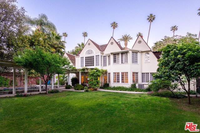 The unique character of the English countryside comes alive as you enter this charming property w/spectacular guest house, located in one of the most prestigious locations, north of sunset. The main house is apx. 5,300 sq ft w/ 4 bedrooms up including a huge, bright master suite "retreat" w/high vaulted ceilings, maid's room and bath, and 5 additional bathrooms. Spacious living rm w/fireplace, family room and formal dining room look out to the lush peaceful gardens w/very tall thick mature trees making you feel like you are in the bois de boulogne in Paris. Redone kitchen capturing the true country feeling w/family breakfast area and top-of-the-line appliances overlooks the amazing grounds. Large swimming pool w/spa. Sauna. The great indoor/outdoor flow is perfect for entertaining. The guest house is a home by itself with 3 bedrooms + loft, 2 bathrooms, library/den and living room. Entertainment area by the pool w/loft. Close to Beverly Hills Hotel.