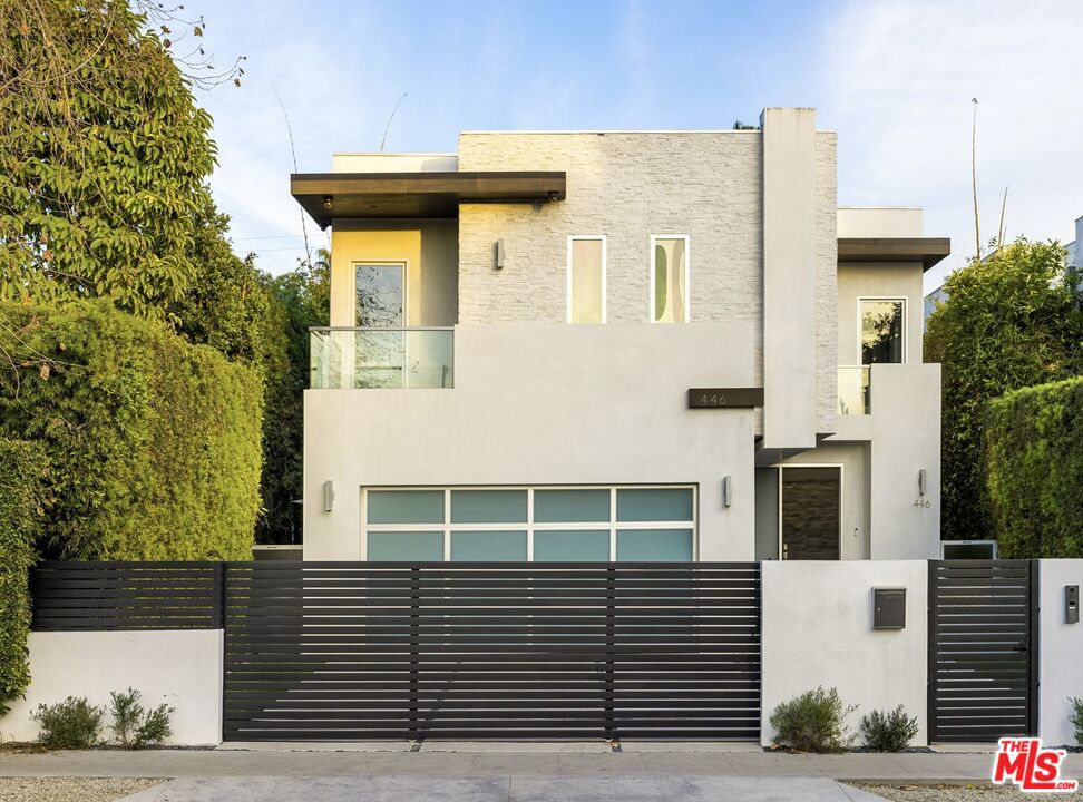 Welcome to 446 N Orlando Ave., a stunning modern sanctuary located on one of the most sought-after blocks in West Hollywood. This gated and private two-story residence is designed for those who value elegance, comfort, and convenience. Upon entering, you are greeted by a tranquil water feature in the front yard, setting the tone for the serenity within. The home is flooded with natural light, accentuated by large living room windows and recessed lighting throughout. Beautiful porcelain tile flooring flows seamlessly through the spacious living areas, including a living room with a cozy fireplace and a family room featuring its own fireplace. The chef's kitchen is equipped with top-of-the-line Miele appliances, ample cabinetry, a temperature-controlled wine cooler, and a dishwasher, making it a perfect space for entertaining. Modern finishes and fixtures enhance the home's luxurious feel, while smart home technology, central heating, and air conditioning ensure year-round comfort. A dedicated laundry room adds even more convenience to this thoroughly designed home. Upstairs, you'll find three spacious en-suite bedrooms, each designed for privacy and relaxation. Plus, an additional office space can easily be converted into a fourth bedroom, offering flexibility to suit your lifestyle. A stylish powder bath with a shower is conveniently located on the first floor. The private backyard is an entertainer's dream, complete with a built-in grill, outdoor fireplace, and a serene dog run. The sparkling pool and spa provide the perfect retreat for relaxation or hosting guests. Practical features include a 2-car garage currently set up as a gym, a driveway with an EV charger. This exquisite home offers the ultimate West Hollywood lifestyle, combining modern luxury with timeless charm, and is available for a minimum 13-month lease term. Don't miss the opportunity to experience it for yourself!