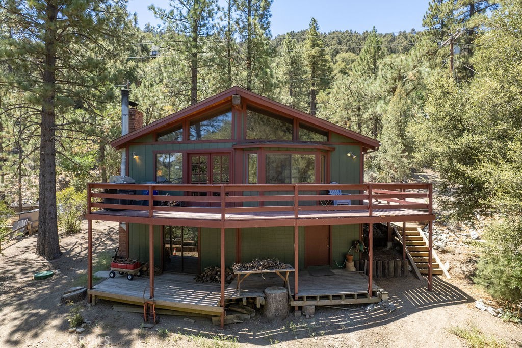 Welcome to 15529 San Moritz Drive, nestled in the picturesque community of Pine Mountain Club, California. This charming 2-bedroom, 2-bathroom home offers a unique opportunity to embrace mountain living, surrounded by a breathtaking 1.7 million acres of National Forest.
Step inside to discover a dated yet well-maintained residence featuring level access to the main floor. The versatile bonus room provides the perfect space for a potential third bedroom, home office, or creative retreat. Enjoy the tranquility of your surroundings, with the property framed by majestic Jeffrey pine and oak trees.
Recent updates include a newer roof and exterior paint. For added convenience, the home is equipped with laundry hookups, and has an approximately 100 sq ft workshop, ideal for hobbies or extra storage. Cozy up on cooler evenings beside one of the two inviting wood-burning stoves. This home is a true gem, offering comfort, convenience, and a deep connection to nature.