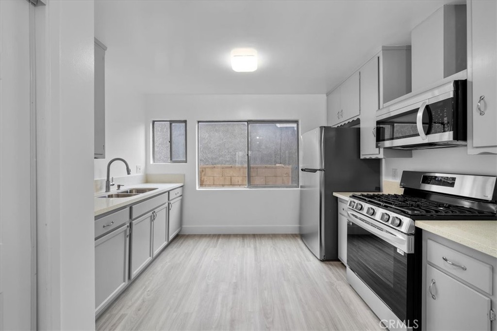 Welcome to this newly renovated, light and bright two bedroom/one bathroom apartment. This spacious first floor unit is 866 square feet and is located on a very quiet street in the desirable Vista Del Oro neighborhood. Featuring new kitchen appliances (refrigerator, microwave, and gas range), side by side washer and dryer, and 1-car garage, this unit is move-in ready! Large windows with views of the neighborhood give lots of natural light to each room. Don't miss out on this great opportunity! Please note that first month's rent, last month's rent and security deposit are due at signing. Tenant pays back Landlord $50 per month for water in addition to rent. Monthly gas, electric, trash, and internet is the responsibility of the tenant.