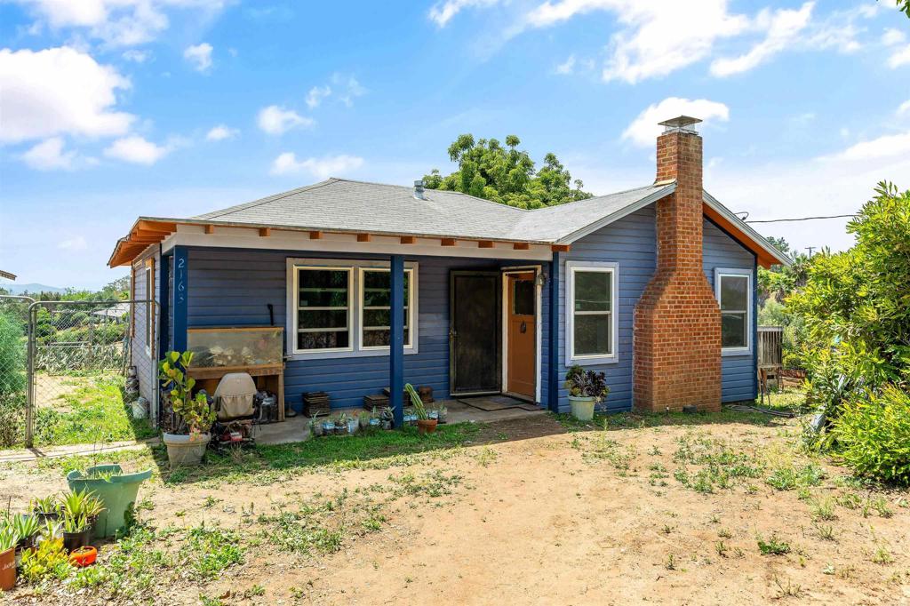 Rare Legacy Property in Fallbrook – First Time Offered in 73 Years Step into the heart of Fallbrook’s coastal country living with this rare 1.16-acre homestead, filled with charm, history, and endless possibilities. For the first time in over seven decades, this beloved family property is available to the public. The 2-bedroom, 1-bath farmhouse is full of character, featuring original hardwood floors, built-in wardrobes, a wood-burning fireplace, and a sunlit mudroom with a built-in breakfast nook—perfect for soaking in peaceful south-facing views and ocean breezes with your morning coffee. Thoughtful updates include a remodeled kitchen, energy-efficient windows, ductless mini-split A/C, and all-electric appliances—providing a solid foundation for your vision and future enhancements, such as solar power. Outside, the property embraces a slower, more sustainable lifestyle: hang laundry on the line, tend your own food forest, gather fresh eggs, or watch horses graze at sunset. Fencing, corrals, and extra materials are already in place to adapt for animals. Mature fruit trees—sapote, cherimoya, and macadamia—dot the landscape. A detached 2-car garage has been converted into an apartment, offering flexibility for guest space, rental income, or restoration back to its original use. Whether you dream of a homestead, hobby farm, or simply a peaceful retreat, this one-of-a-kind property offers timeless character, modern comforts, and a story ready for its next chapter.