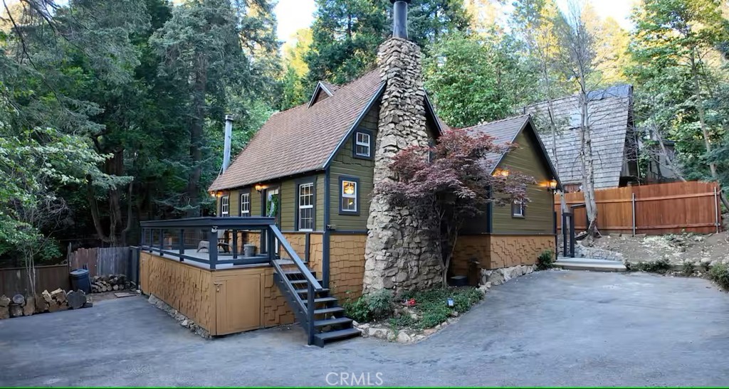 Charming Lake Arrowhead Cottage in the Heart of the San Bernardino Mountains Centrally located in scenic Lake Arrowhead, this inviting cottage offers the perfect blend of comfort, nature, and convenience. Tucked in the heart of the San Bernardino mountains, the home is an ideal retreat for families, friends, or as a high-demand rental investment. Cozy up by the fireplace, unwind in the hot tub, or enjoy the wraparound deck that seamlessly extends indoor comfort into the great outdoors. The park-like setting offers ample open space—perfect for sledding in winter, playing with the kids, birdwatching, or morning yoga beneath the trees. Just minutes from popular attractions including Lake Arrowhead Village, Lake Gregory, Big Bear, SkyPark at Santa's Village, and the Tudor House. Outdoor enthusiasts will love the nearby hiking and biking trails, boasting panoramic views along the iconic Rim of the World. The home features a fully equipped kitchen and BBQ area—ideal for cooking your favorite meals. The property spans two lots totaling over 10,000 sq ft, offering potential for a second unit or a separate home (buyer to verify zoning and permit regulations with San Bernardino County). Included with the sale are all appliances and most furniture, décor, and accessories (with a few exclusions). The home is currently permitted for short-term rentals (STR) and is ready to start generating income immediately. Serviced by Arrowhead Villas Mutual Services Company (not an HOA), utilities include water, trash, road maintenance, and snow plowing. Please note: this property is not within the Arrowhead Lake Association boundaries and does not include lake rights. Whether you're looking for a full-time residence, a relaxing weekend escape, or an income-producing rental, this turnkey mountain cottage offers endless possibilities. Sale incudes 2 lots: Lot 1 (with house) APN 033206429 4,800 sf Lot 2 (vacant) APN 033206429 4,838 sf Seller is open to including the AIRBNB LLC and all associated rights for the right offer.