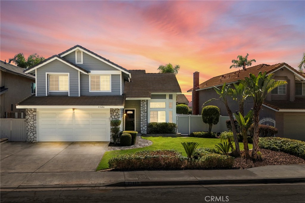 What a great location, with a view of the hills on a single-loaded street that is quiet except for the sound of nature! This ready to move into home is worth checking out. Nice curb appeal to start and when you enter the home it feels incredibly open, light, and bright. Cathedral ceilings provide the spacious feel for the living room and dining room. Wide plank vinyl flooring adds to the luxurious feel that runs throughout the home. The kitchen views the backyard and is open to the family room. With granite counters and well-maintained cabinetry if just feels comfortable with a 5-burner stove and oven you are ready to prepare that special meal. The family room also enjoys a view to the backyard and provides the ambiance of a stone covered fireplace and a slider to the go outside. The first floor is completed with a half bath and an inside laundry room. At the top of the stairs and the first thing you notice is the loft that is used as an office and a sitting area, perfect for that early morning reading and relaxing or to review your emails without disturbing anyone. The primary bedroom is good sized and full of light as well. Two separate mirrored closets provide that needed space for your clothes. You will love this room and the primary bath. The bath provides double sinks, a separate shower and bathtub and a private toilet room. To finish the second floor are two additional bedrooms to the front of the home with views to the hills and a hall bath to serve those bedrooms. Let’s go outside. The backyard is exceptionally low maintenance with artificial grass in the back and the side with a putting green. Pavers are all around and the Aluma wood patio cover keeps you cool with two ceiling fans. Such a great place for a meal or that weekend breakfast or with friends for a party. With newer AC and furnace and fresh paint and great flooring, just come on over and see your next home. Parks are nearby and great schools are both extra pluses.