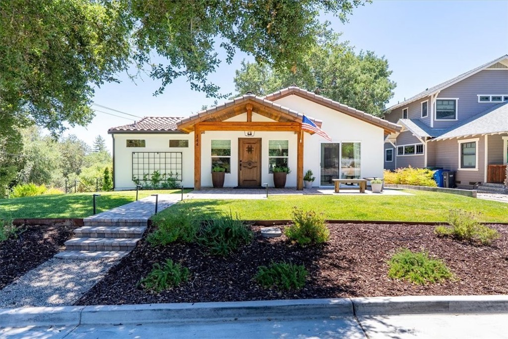 Experience the charm of this fully renovated Modern Spanish residence located on the coveted Westside of Paso Robles! Nestled on an elevated corner lot with convenient rear alley access, this stunning property offers easy proximity to downtown restaurants, shops, and the enchanting Wine Country. The inviting single-level floor plan features three bedrooms and two bathrooms. Enter through the redwood portico into a warm living room adorned with a speakeasy front door, smooth trowel-finished walls, cathedral ceilings, recessed lighting and charming arch details. At the heart of the home, the eat-in kitchen is a true entertainer's delight, showcasing crisp white shaker cabinetry, quartz countertops with a herringbone backsplash, ZLine gas range, Vissani hood and a well-equipped butler’s pantry featuring rift white oak cabinetry, Pinky's iron/glass door, along with a Zephyr wine fridge. Retreat to the owner’s suite, where comfort meets luxury with a walk-in closet equipped with an Elfa system and a spa-like bathroom boasting dual sinks and a curbless walk-in shower enclosed in frameless glass with tiled surround and Hansgrohe fixtures. Two additional bedrooms offer versatility, one of which features access to a front patio that can be transformed into a cozy home office or study. An inviting full bathroom with an extra-deep bathtub, frameless glass enclosure, and dual vanity ensures out-of-town guests feel welcomed. The double living space is perfect for summertime gatherings, featuring a paver patio with a gas firepit, a lush lawn area, and a lower terrace accented with oak and olive trees. Additional highlights include a laundry room with custom cabinetry, an attached garage, custom window coverings, a Navien tankless water heater, AC Pro heat pump/air conditioner, freshly painted exterior, and a beautifully landscaped front yard. This home truly encapsulates the best of Paso Robles living!