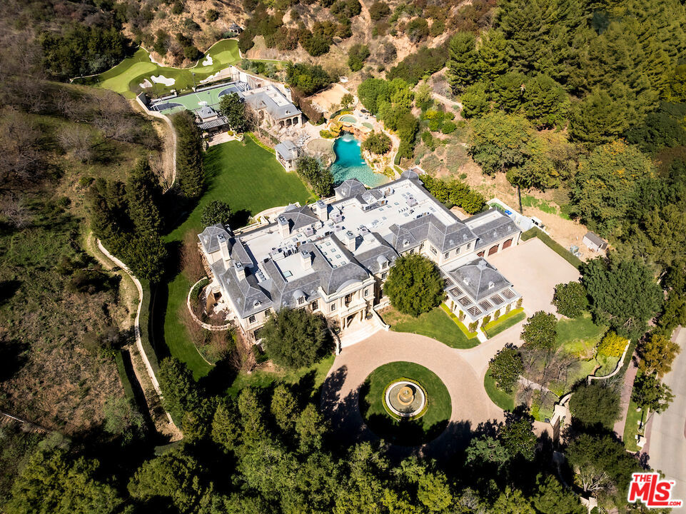 Introducing the premier estate in North Beverly Park, the most exclusive gated community in Beverly Hills and all of the West Coast. Recently renovated, this Richard Landry-designed masterpiece spans an extraordinary 30,500 square feet on an unparalleled 6.2-acre lot. The estate offers 12 bedrooms, 20 bathrooms, and world-class athletic facilities like no other, featuring an expansive guest house, an oversized sport court perfect for professional basketball games, pickleball, a skate park, a five-hole golf course with a driving range, and a resort-style grotto pool with slides, all set within this one-of-a-kind sprawling compound.Just one minute inside the guard gates for quick access in and out, the estate features an expansive gated motor court with a striking hotel-like waterfall entry, along with an additional motor court for large families, staff, and drivers, plus a five-car garage. A grand two-story entry foyer leads to an exquisite living room, formal dining room, and a breathtaking two-story paneled library. The main level also showcases an expansive kitchen and family room complex, complete with pantries, a separate prep kitchen, and dedicated staff quarters and offices. Designed for ultimate entertainment and wellness, the lower level boasts a state-of-the-art home theater, professional gym, wine and cigar cellar, and a sophisticated tasting and smoking lounge. The primary living spaces seamlessly blend indoor and outdoor luxury, opening to vast patios, sprawling lawns, and resort-inspired amenities. A rare opportunity to own one of Los Angeles' most significant estates, combining modern updates with timeless grandeur, designed to rival any luxury resort experience. Shown exclusively to pre-qualified clients.