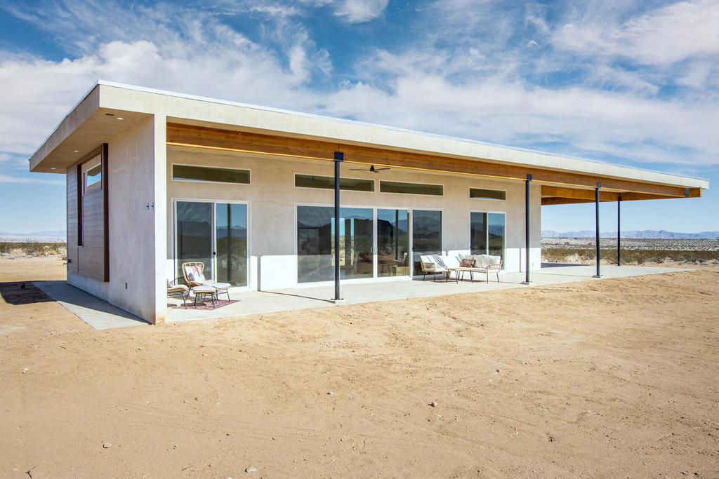 Brand New Construction with 10 big Acres featuring over height ceilings for a large feeling 2 bedroom 2 bath custom home. Forever views with property sited directly across from conservation land in a beautiful section of Joshua Tree. Home features a Paid Solar system, modern open floor plan with high ceilings, and boundless views of open desert serenity. Your own private gate is located directly off a paved road at the top of Joshua Tree. Just a short drive to all the amenities this location is that perfect combination of privacy and open space with ease of access to town. Joshua Tree National Park, Johnson Valley Off Road Park, Indian Cove camp grounds, and more are all within a short drive from your new property. Joshua Tree is home to a growing number of artists, creatives, and talented individuals. As more and more work from home opportunities grow it's clear JT and the high quality of life in the area with minimal traffic, pollution, and urban stress is the place to invest. This property is the next evolution in modern living and would make for an amazing home base to all of Southern California. Anyone seeking a new full time residence, vacation rental, and investment should schedule an appointment today. Large parcel size opens up future expansion for additional dwellings, pool, vegetable and fruit gardens, and more. Don't wait on this one call now!