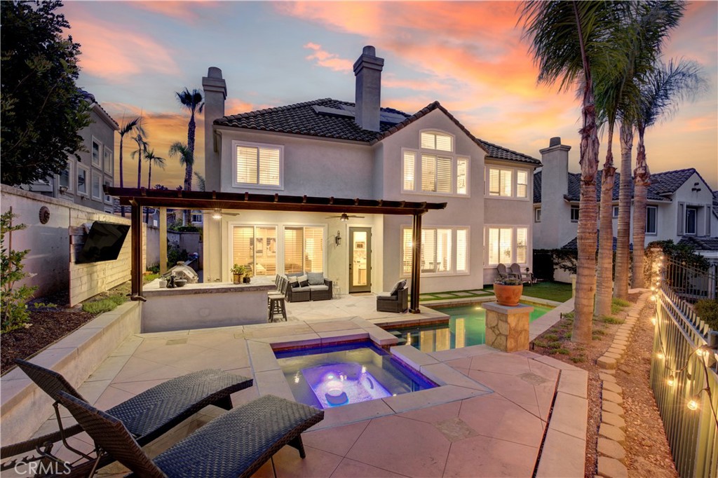 Experience luxury living in a tastefully renovated view home featuring 5 bedrooms, 3.5 baths & 3,316 square feet of living space. The home's elevated position showcases hillside, tree and lake views within the coveted gated community of Dove Canyon. These sights may be enjoyed from the kitchen, informal dining area, family room, formal dining area, primary bedroom retreat as well as the backyard's private outdoor living area, pool and spa. Upon arrival you'll notice a spacious driveway, low maintenance landscaping and a 3 car garage. Enter through the front double doors to the living room's two story ceiling and a preview of the hill & tree views seen through the dining area. The remodeled chef’s kitchen includes quartz countertops, designer backsplash, a dual basin under-mount sink, a pot filler over the range, stainless steel appliances, a breakfast bar that seats 4 and an additional eating area that comfortably seats 8. Appliances include a 6 burner Thermador gas range top with griddle, Bosch dishwasher as well as a KitchenAid double oven and refrigerator. The spacious open concept between the kitchen and family room, with its cozy fireplace, provide an ideal space for relaxing with your loved ones and friends while the clear lines of sight help keep tabs on the party outside. Thoughtfully planned with easy transitions between indoor and outdoor entertaining, the outdoor living area has been designed for all seasons: an Alumawood cover with recessed lighting, outdoor fans as well as a built-in BBQ, wine fridge, storage and a counter that comfortably seats 4 are all located steps from the open concept kitchen and family room area. The backyard is finished off with a thoughtfully designed saltwater PebbleTec pool/spa and turf area accented with drought tolerant landscape. The downstairs is finished by a bedroom with an ensuite remodeled bath, laundry area and powder room for your guests. There are no steps from the direct access garage to the laundry area, bedroom, half bath, kitchen, family room, formal dining room and backyard. This home also has room to install an elevator should one have need. Upstairs a spacious primary bedroom awaits featuring a large retreat with fireplace, a remodeled ensuite with a step in shower, separate tub, dual vanity, quartz counter tops and more views of the lake and hills. Built-in storage and three additional bedrooms complete the upstairs. Homes overlooking the lake rarely are available for sale, don't miss this one!