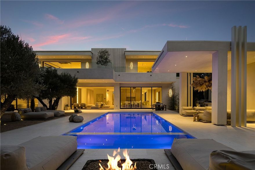 A Sanctuary Above It All...Where Architecture Meets Ascension
Welcome to 17177 Adlon Rd an architectural statement of sovereignty, soul, and sophistication.
Perched above Encino with cinematic views, this newly built estate transcends luxury and enters the realm of legacy living.
From the gated entry to the serene hillside grounds, every square foot was curated to honor privacy, flow, and future readiness. Designed for the discerning visionary, this home offers not just stunning finishes, but a resonant frequency—a place where peace is felt, not just seen.
Whether you’re seeking a private family compound, a luxury wellness retreat, or a smart investment in one of LA’s most future-resilient locations, this is your portal.
• 8,500+ sq ft of indoor serenity
• Panoramic city and canyon views with sunrise alignment
• Primary suite with spa-level energy
• Seamless indoor-outdoor living + curated landscaping
• Fully intergrated Smart home, solar, retreat-grade layout
This isn’t just a home. It’s a fortress of peace, built for what’s coming.
Prime Encino Hills with EASY WESTSIDE ACCESS and VIEWS!! VERY PRIVATE!
Breathtaking new construction that embodies the essence of luxury living—a modern Tulum-style masterpiece crafted by one of Los Angeles' most sought-after builders and designed by Yeara Design Studio.  
Step outside to discover a resort-style backyard that is nothing short of a personal oasis. Dive into the sparkling outdoor pool, unwind in the soothing spa, or entertain guests under the stylish cabana complete with a full bathroom. As the sun sets, gather around the sunken fire pit, perfect for cozy evenings. The gourmet kitchen is a culinary enthusiast's dream, featuring top-of-the-line Miele appliances, custom cabinetry, and exquisite stone finishes that exude luxury. The home offers a spacious layout with a relaxing loft on the second floor, ideal for casual gatherings or peaceful retreats.
Retreat to the master suite, where a Tulum-style spa bathroom awaits, reminiscent of a five-star hotel. Every detail has been meticulously considered, ensuring an atmosphere of tranquility and elegance.
Completing this remarkable property is a generous four-car garage, providing ample space for vehicles and storage.
Located in the prestigious Encino Hills, this home offers easy access to the vibrant Westside and is close to upscale dining, shopping, and top-rated schools. Welcome home.