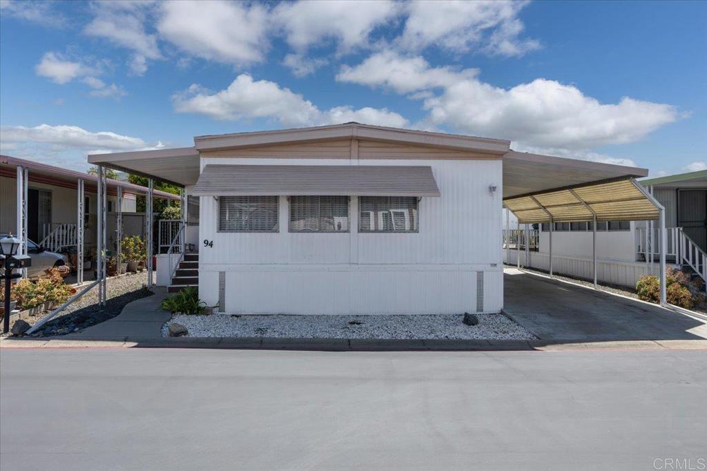 Own your own land & home! No space rent! Located in a 55+ resident owned co-op share community, this home has recently been upgraded with a newer furnace, water heater, and roof (3-5 years new). The monthly HOA fee is $355 and includes trash, water, cable TV, and internet. Amenities include a clubhouse, library, billiards, saltwater heated pool/spa, dog park, exercise room, laundry room, BBQ, social activities, office staff and property maintenance for common areas. RV parking available for an additional small fee on availability. The interior of this home is light, bright, and cheerful! This large lot offers a spacious back yard with garden box, 2 sheds, plus an enclosed porch that provides additional usable space not listed in the square footage! This is a great opportunity to own affordably in North County San Diego! Very convenient location; Walking distance to Sprouts, Albertsons, Rite Aid, dining & shopping, near Downtown Vista; breweries, movie theater, transportation, Moonlight Amphitheater & a short drive to beaches! Ask Agent if you need a referral for a lender that can finance this property!