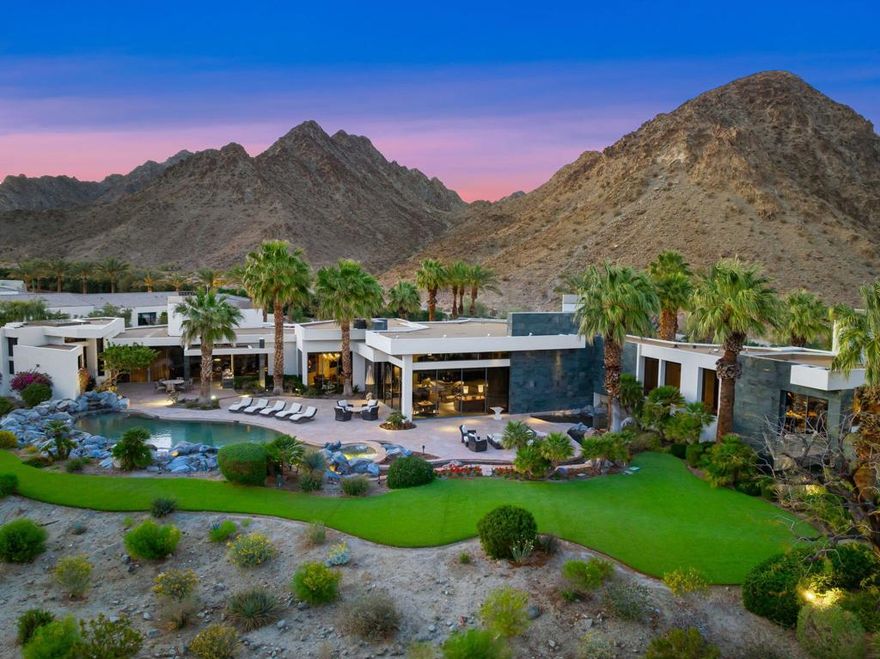 Set within the prestigious Quarry Golf Course community, this exceptional estate, crafted by internationally acclaimed architect Guy Dreier, offers a refined living experience that blends modern elegance with unparalleled luxury. Positioned on an elevated 2-lot south-facing property, the home commands breathtaking panoramic views of the mountains, fairways, and tranquil lakes creating an idyllic setting for both relaxation and sophisticated entertaining.Spanning an impressive 10,857 sq ft, this estate features 5 bedrooms and 9 bathrooms, providing ample space for both intimate family living and grand-scale entertaining. The architectural brilliance of Guy Dreier is evident throughout, with a seamless fusion of organic design and contemporary finishes. Floor-to-ceiling windows invite natural light, framing the stunning vistas and bringing the outdoors inside, creating a harmonious flow between the spacious interiors and expansive outdoor living areas.The property also includes 3 private casitas, each thoughtfully designed with kitchenettes, and decorated with an eclectic mix of global influences. From custom French armoires to Asian-inspired lanterns, and African-inspired hardware in the bathrooms, every detail has been carefully curated to evoke the feeling of luxury and travel.A must-see feature of this estate is the glass walkway leading to the office, where the stunning leather tile floors and panoramic views combine to create a truly breathtaking space. This is just one example of the thoughtful details throughout the home that can only be admired in person.From the resort-style pool and expansive terrace to the world-class Quarry Golf Course just moments away, this estate offers a lifestyle of unparalleled comfort and refinement. The Quarry, celebrated for its exclusive design and exceptional course, provides an elite golfing experience unlike any other.More than just a home, this property represents the pinnacle of architectural excellence and offers a private desert sanctuary. Seize the opportunity to own a truly extraordinary piece of The Quarry.