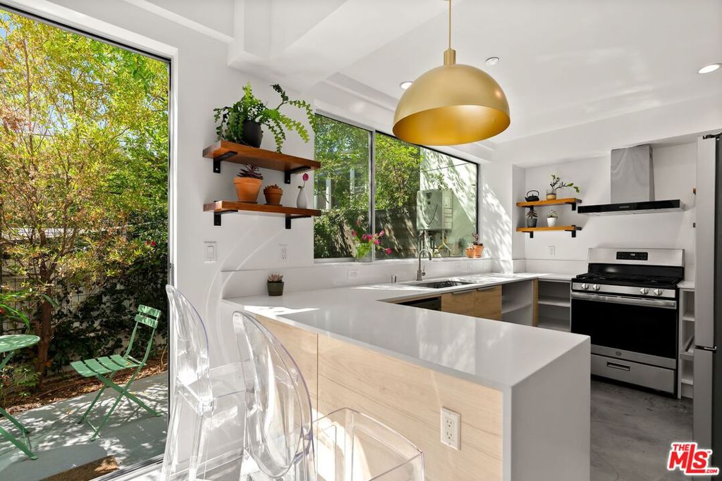 Designed by esteemed AIA architect Jennifer Wen, this striking contemporary residence welcomes you with a large, light-filled entry featuring soaring 18-foot ceilings, creating a dramatic sense of space and elegance. The home blends refined architectural details with the best of California's indoor-outdoor lifestyle.The modern chef's kitchen boasts sleek finishes and flows seamlessly to a spacious outdoor patio adorned with a bespoke gardena perfect setting for morning coffee or evening gatherings. The versatile lower-level den offers endless possibilities, whether used as a private office, media lounge, or intimate dining space.Upstairs, a stylish loft with sliding glass doors opens to a sun-swept balcony, ideal for a secondary workspace or reading nook. The home features three generously sized bedrooms and three full bathrooms, including a serene primary suite with a spa-inspired bath showcasing a double sink, soaking tub, and walk-in shower.Ascend to the expansive roof deck, where ample seating and a dining area create an unparalleled venue for sunset views and effortless entertaining. Additional highlights include two side-by-side parking spaces in a secure private garage, extra storage beneath the stairs, and thoughtful design throughout.Perfectly situated within walking distance to world-class shopping and dining, and moments from the renowned Santa Monica beaches, this residence offers a lifestyle of luxury, convenience, and year-round incredible weatherthe perfect setting to enjoy coastal living at its finest.