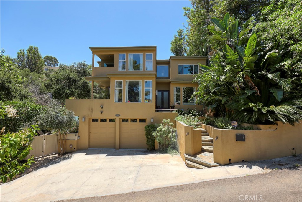 Hurry to this dramatic move-in ready multi-level custom contemporary home in the exclusive Calabasas Highlands enclave neighborhood. Mountain, canyon, treetop and peek-a-boo City views from many rooms. Enjoy the being away from it all feeling yet still close to all. Experience the custom quality of this home immediately. Double door atrium entry leads to main level sun filled rooms with soaring ceilings. Elegant and comfortable living room looks out to the views. Large family room perfect for casual evenings. Upgraded kitchen features Viking appliances. True formal dining with fireplace opens to rear entertainers patio deck. One bedroom suite on main level is ideal for guest or maid. Upstairs the exquisite primary suite features peaceful views, balcony deck, spacious walk-in closet and private luxury bath including oversized shower and modern dual vanity. Huge secondary bedroom has adjoining playroom/den. Third bedroom upstairs has been converted to large walk-in closet but may easily be converted back to bedroom with closet. Lower level features a bonus room ideal as gym, studio or theater room and has an adjoining huge storage room that could be converted to another bathroom. This home is ideally suited for those who love outdoor entertaining too. The outdoor areas has been customized to feature three patio/deck levels that can easily accommodate large parties and features a built-in barbecue, relaxing conversation areas, play area and even possibility for small pool or swim/spa. This special home offers the perfect blend of peaceful life surrounded by nature with easy access to Calabasas Commons shopping/hot spots and schools. Hiking trails and a park nearby too. A must see...a must buy!