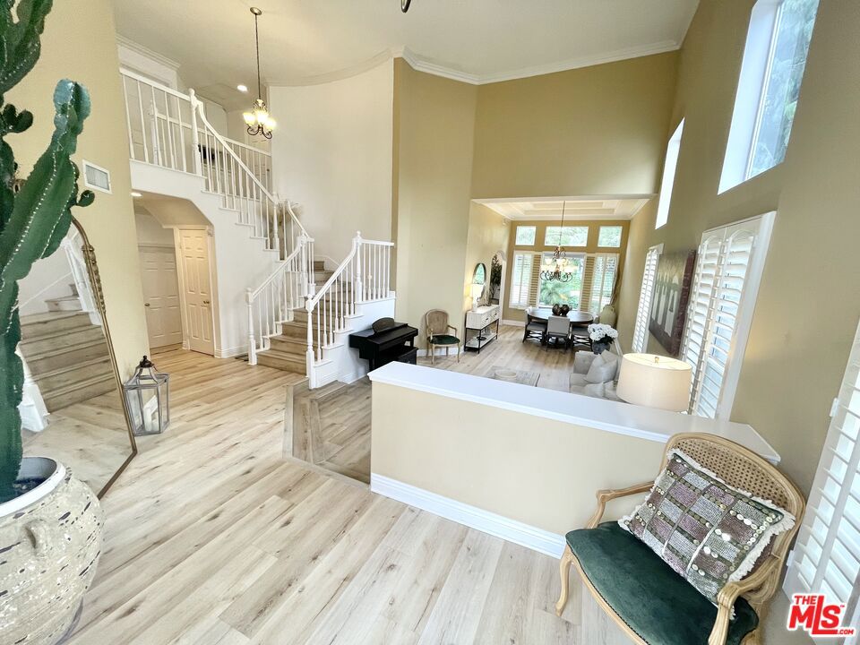 Nestled on a cul-de-sac with inviting landscaping in the beautiful community of Northbridge Point. This light filled four- bedroom three- bath with bonus room exudes the warmth of your family dream home. Formal entryway leads to a spacious living room that flows into the dining room featuring a tray ceiling, crown molding, plantation shutters and views of the tranquil pool, spa and gorgeous backyard area for entertaining. A gracious archway leads into a tastefully upgraded kitchen with stainless steel appliances, eat-in breakfast nook and breakfast bar. The family room boasts a cozy fireplace perfect for family gatherings; you will also find newly installed wood flooring throughout the first floor. One bedroom/ office is conveniently on the main floor as is an updated bathroom and separate laundry room. Upstairs the luxurious primary suite awaits with tree top views, fireplace, walk-in closet and generous en-suite bathroom. Two additional bedrooms are to be found upstairs. Special features include two Tesla battery electric chargers, three car garage with loft space for additional storage. Solar panels installation. Steps to serene walking paths. This community offers convenient access to an additional pool, playground and courts. Minutes from shopping, restaurants and freeway.