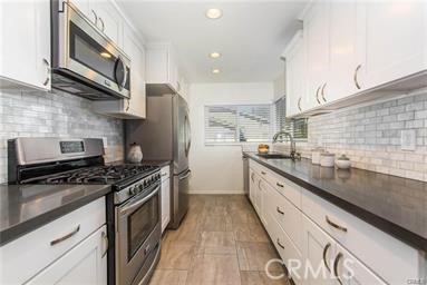 Charming condo "inside the loop" in Woodbridge. Upper end unit with private porch at entrance. Open floor plan. Remodeled kitchen with quartz countertops, soft close cabinets, and stainless steel appliances including Refrigerator. Other upgrades include dual pane windows, recessed lighting in each room, remodeled baths. Private deck off of Primary Bedroom. Interior Laundry with Washer & Dryer included. Located within close proximity to Award Winning Irvine Unified Schools, and access to incredible Woodbridge amenities like South Lake Beach Lagoon, numerous Parks and Pools, Tennis, Recreation Trails, and Lakes. Minutes to UCI, Transportation, World Class Shopping, Beaches, and Freeways. Newer Flooring and paint will be touched up like new. Washer, dryer, refrigerator included w/out warranty.