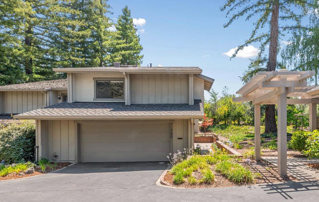 Bordering the 10th hole at Sharon Heights Golf and Country Club, this end-unit townhome offers fairway and wooded views in a private setting at the front of the community. Soaring ceilings and dramatic walls of glass create a light-filled ambiance throughout the multi-level floor plan with 3 bedrooms, including a top-floor primary suite with open sitting room and private deck. Spacious living room with fireplace, formal dining room, and all-white eat-in kitchen opening to a wraparound low-maintenance yard. EV charging, remote-controlled blinds, keyless entry, and a separate laundry room. Community pools, spas, and private event space, all minutes to Sharon Heights Golf and Country Club, Rosewood Hotel, Sand Hill Road venture capital centers, and Stanford University. Excellent Las Lomitas schools.
