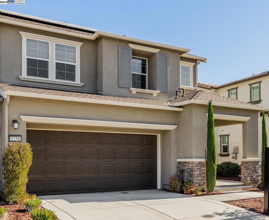 Welcome to 5758 Tournament Ct, located in the highly desirable Tracy Hills community! This stunning two-story home offers 4 spacious bedrooms, 3 full bathrooms, and 2,300 sq ft of living space on a premium lot. The open-concept floor plan features a chef’s kitchen with an oversized island, quartz countertops, full tile backsplash, stainless steel appliances, and walk-in pantry—perfect for entertaining. The light-filled great room flows seamlessly to the backyard, ideal for indoor/outdoor living. Downstairs includes a full bedroom and bath, perfect for guests or multi-gen living. Upstairs boasts a large loft, laundry room, and a luxurious primary suite with dual vanities, soaking tub, walk-in shower, and oversized closet. Energy-efficient upgrades include solar, tankless water heater, and EV charger. Enjoy Tracy Hills’ resort-style amenities: clubhouse, pools, fitness center, walking trails, playgrounds, and top-rated schools. Conveniently located near Hwy 580 for easy commuting. A true turnkey home with modern design and community lifestyle!