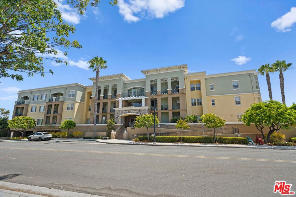 South Bay's most exclusive and sought-after +55 Community, live the resort lifestyle in the heart of Torrance in between a park and a nature preserve about 3 miles away from the beach. Feel the ocean breeze and discover the prestigious complex of Trade Winds. This gorgeous newly remodeled sanctuary corner suite is unique to the market and feels like a coastal vacation condominium with all the comforts of a luxury home. Walk through the well manicured front yard adorned with palm trees into a one-of-a-kind vintage lobby, take the elevator or the classical curved stairs to your new home on the 2nd floor. Upon entering through the front door the property expands to a massive open-plan Great Room with soaring high ceilings, all bathed in endless warm natural light from the oversized windows and expansive balcony glass doors overlooking the sparkling pool. The state-of-the-art chef's kitchen is highlighted by a top-of-the-line gourmet appliances, a large center island with bar seating, stellar quartz countertops and stylish backsplash, custom and thoughtfully built cabinetry with ample storage space, it stands as a place of both culinary creation and contemplation. The grand primary bedroom retreat wing, positioned at the home's rear -with no neighbors shared walls- and opening up to the balcony through glass door leading to its own peaceful veranda for morning breakfast coffee, presents a refuge of relaxation together with its ensuite spa bathroom, with designer tile and countertops, a breathtaking luxurious soaking tub, epitomizes the resort-like experience; altogether with its own wide walk-in closet. A second deluxe bedroom, a luxury full bathroom, plus a chic laundry room, complete the extensive 2-bedroom 2-bath layout. There's two assigned parking spaces in the gated underground garage, and an extra private storage space to secure all the bulky items. Throughout this distinctive property you'll find iconic craftsmanship specifics and meticulous attention to bespoke fine details, seen clearly in the recreation room with custom hand-crafted wood billiard table, the fitness room with high performance equipment and the outdoor thoughtfully landscaped courtyard grounds surrounding the pool and spa area, completely encouraging a blissful and healthy lifestyle that has no limits. This home is centrally positioned to enjoy the vibrant city of Torrance and all what the South Bay has to offer for you, so come over and discover the laid-back suburbs and retire like a king and queen. This residence, contemporary and elegant, design-forward and timeless, stands as a testament to the beauty of integrated living. A must-see slice of heaven!