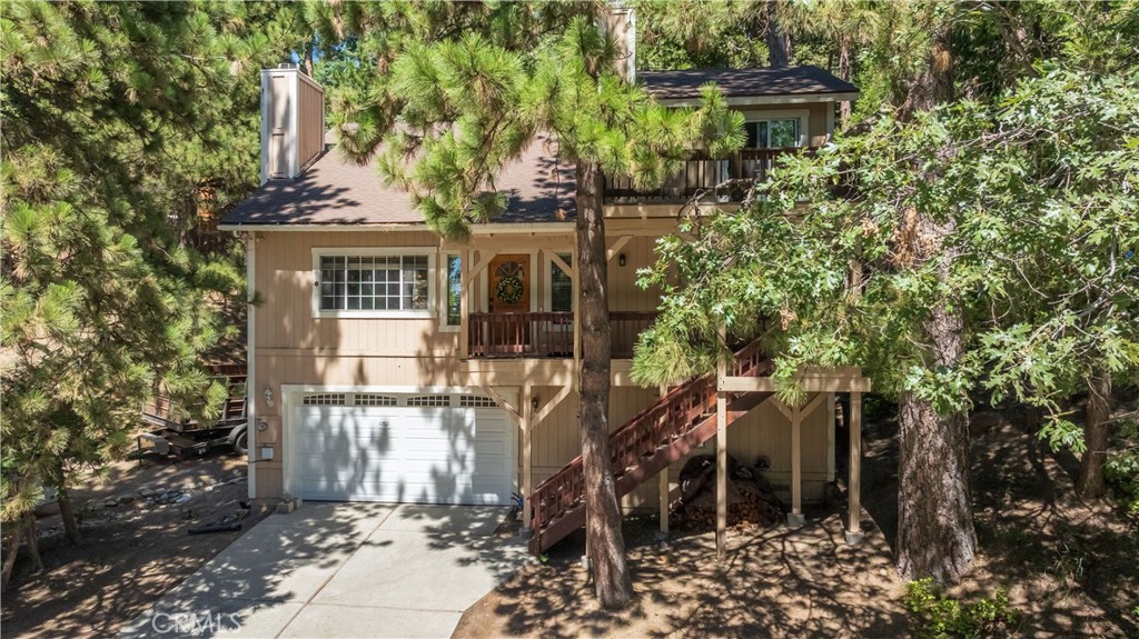 Welcome to this inviting mountain home, ideally situated at the start of a quiet cul-de-sac, offering both tranquility and easy access for commuters. With a new roof and new flooring throughout, this home is move-in ready and full of potential.
The main level features two generously sized bedrooms and a full bathroom, along with an open kitchen and dining area that leads to a deck—perfect for taking in the fresh mountain air. The living room showcases vaulted ceilings and a beautiful stone fireplace, adding warmth and character to the heart of the home.
Upstairs, the private master suite offers a brick fireplace, walk-in closet, and sliding glass doors to its own deck with peaceful mountain views after a long day of activities.
Downstairs, you'll find a laundry room, build-up storage area, and direct access to an oversized two-car garage with a workbench and additional storage; perfect for tools, hobbies, or weekend gear.
This is a solid mountain home in a desirable location, ready for you to enjoy or personalize over time.