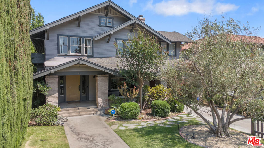 This stunning Craftsman blends original character with thoughtful modern updates. Step into the spacious living room, filled with rich wood trim and timeless charm. The formal dining room features wood-beamed ceilings and classic wainscoting, opening seamlessly to a cozy den, a breakfast room, and a beautifully updated kitchen with an island and modern appliances. A walk-in pantry, laundry/storage room, and a convenient half bath complete the main floor. Upstairs, a charming staircase leads to the large primary suite with a gorgeous new bathroom featuring double sinks and access to a private rooftop deck. Two additional guest bedrooms share a character-filled hall bath, and there's a versatile playroom, office, or optional fourth bedroom.The backyard is an entertainer's dream with a covered dining patio overlooking the private garden. The detached garage (an additional 500 sq.ft.) has been converted into a flexible office, playroom, or hobby space, with an attached gym. Property has been updated with newer central air and heat, copper plumbing, and electrical. Nestled on a picturesque tree-lined street surrounded by beautifully restored homes, this is a rare opportunity to own a true piece of architectural history (HPOZ). Active neighborhood community with yearly Halloween party.