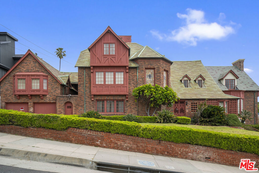 1st time on the market in 90 years! This Stately English Tudor compound has been lovingly maintained offering an unmatched opportunity to re-create an architectural masterpiece. This home is set on one of the biggest lots in the area, with an expansive 37,081 square foot flat lot located in the highly desired Hollywood Hills-West. This home has over 10,149 square feet of total living space. This luxurious residence offers 7 Bedrooms and 7 baths, plus 2-bedroom 1 bath carriage house is located above the spacious garage. Designed by the prolific architect in 1923 it has tons of original details throughout; Leaded stained-glass windows, gleaming original hardwood floors, crown moldings, hand stenciled Mahogany coffered ceilings, and beautiful entry with a graceful staircase, all Reminiscent of luxury and glamour of the 1920's. This house has 4 floors, including a daylight basement with 2 fireplaces, perfect for a screening room and more entertainment. The 1st floor features vaulted ceiling in the grand entrance, wood paneled den/ office & fireplace, an elevator, two large formal living rooms, sunroom, two fireplaces, a huge formal dining room, chefs kitchen with original wall size "ice box", dumb waiter, all with French doors leading out to the expansive brick patios, & park like compound. The sun filled home exudes elegance and style in the middle of the most coveted neighborhood in LA. This Majestic legacy property with impressive architectural statements, such as a steeply gabled roofline, cooper roof, towering chimneys echoing the hallmarks seen at the grandest homes in England and abroad; intricately carved doors and masterful use of paneled walls in primary rooms & hallways. Offering absolute privacy among majestic gardens and mature trees, this Hollywood Hills Iconic estate is unlike anything else you've ever seen. The huge park like backyard, has room for pool, tennis, pickle ball courts, garages, guest houses, the possibilities are endless, plus major outdoor entertaining, fresco dinning areas and more. This Hollywood Iconic Gem- You've seen it each time you walk to the west entrance of Runyon Canyon, and is this an iconic recognizable architectural masterpiece. By appointment only.