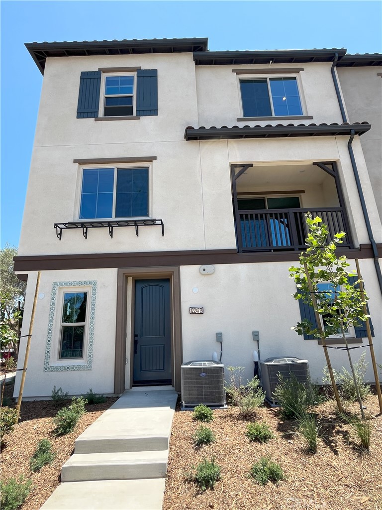 Welcome to this stunning modern tri-level home in the GATED Mirasol community! This brand-new, energy-efficient Plan 2 offers 2 bedrooms, 2.5 bathrooms, and 1,373 square feet of thoughtfully designed living space, complete with an attached 2-car tandem garage. Upon entering, you're welcomed by a bright foyer with a convenient storage closet and direct garage access. As you ascend to the main level, you'll discover an open-concept living area featuring a charming balcony, perfect for entertaining or relaxing in the fresh air. The beautifully appointed kitchen boasts white shaker cabinets, a large island with quartz countertop, and LG stainless steel appliances, including a range, microwave, dishwasher. On the third level, you'll find two spacious bedrooms, each with its own en-suite bathroom. This level also includes a stacked laundry room for added convenience. Centrally located near schools, parks, and more, with easy access to the I-10 and I-605 freeways, offering a smooth commute to both DTLA and Orange County.