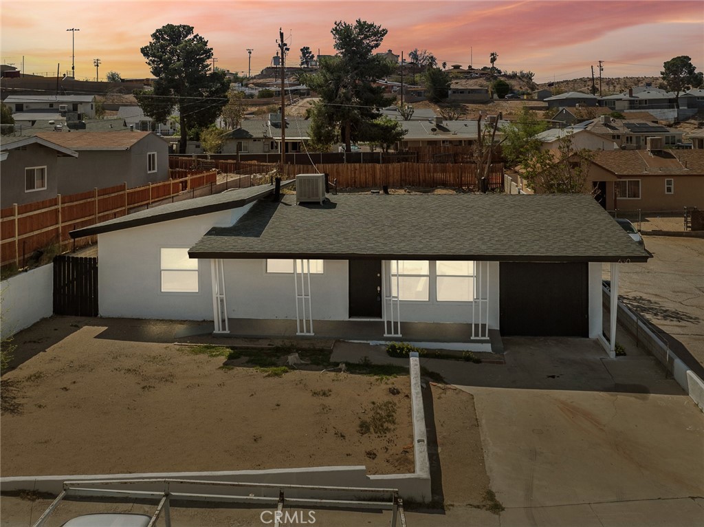 EXCEPTIONAL RENOVATION IN THE HEART OF BARSTOW! This meticulously renovated three-bedroom, one-bathroom home presents a rare turnkey opportunity for discerning buyers. The property has undergone a comprehensive transformation, featuring a new roof and energy-efficient retrofit dual pane windows that enhance both comfort and utility efficiency. Step inside to appreciate the freshly painted interior adorned with elegant three-paneled doors and contemporary fixtures throughout. The home boasts beautiful new luxury waterproof vinyl flooring complemented by stylish baseboards that create a seamless flow from room to room. The bathroom has been thoughtfully updated with tiled tub shower and coordinating tiled floors, creating a spa-like atmosphere. At the heart of this home, the newly remodeled kitchen showcases upgraded self-closing cabinets with sophisticated frosted glass accents—perfect for the home chef who appreciates both style and functionality. Outdoor living is equally impressive with a generous backyard featuring a covered patio ideal for al fresco dining or weekend gatherings. A large storage shed provides ample space for gardening equipment, or recreational items. Large garage featuring washer and dryer hookups with ample storage racks. Situated in a convenient location, this home offers proximity to shopping destinations, educational institutions, and recreational parks. The property's commuter-friendly position makes daily travel a breeze. Why continue house hunting when your dream home awaits? This beautifully renovated property offers the perfect blend of modern updates and comfortable living spaces—simply move in and make it yours!
