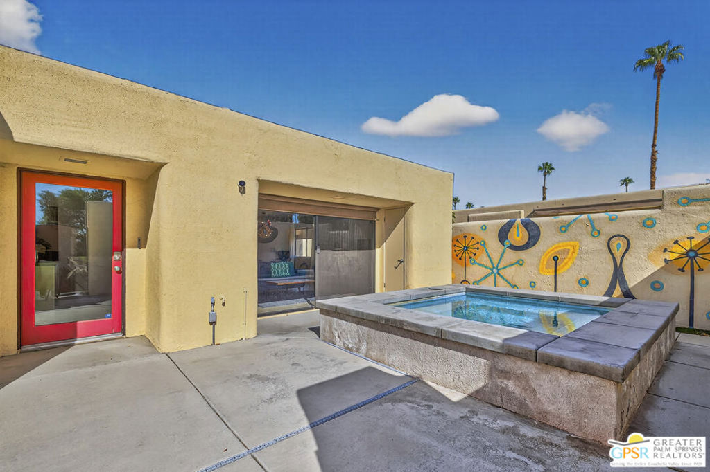 Experience the quintessential Palm Springs lifestyle in this beautifully updated, fully furnished 2-bedroom, 2-bathroom condo located in the highly sought-after Greenhouse community. Flooded with natural light, this inviting single-level home features a sleek galley kitchen with granite countertops and modern appliances perfect for both everyday living and entertaining. The bright and open floor plan flows effortlessly into an oversized private patio, complete with artificial turf accents, a custom mural, and an inviting hot tub/spa. This unique outdoor retreat offers seamless indoor-outdoor living with mountain and courtyard views ideal for relaxing or hosting friends. The spacious primary suite offers a walk-in shower, large closet, and direct access to the patio, while the guest bedroom and stylish hall bath provide a comfortable oasis for visitors. Enjoy the convenience of in-unit laundry, central air, and dedicated covered parking. Greenhouse residents indulge in resort-style amenities: lush landscaping, two sparkling pools and spas, tennis courts, and a gated entry for peace of mind all just minutes from the vibrant dining, shopping, and entertainment of downtown Palm Springs Don't miss this opportunity to embrace the best of desert living and make 415 N Hermosa Dr your new home!