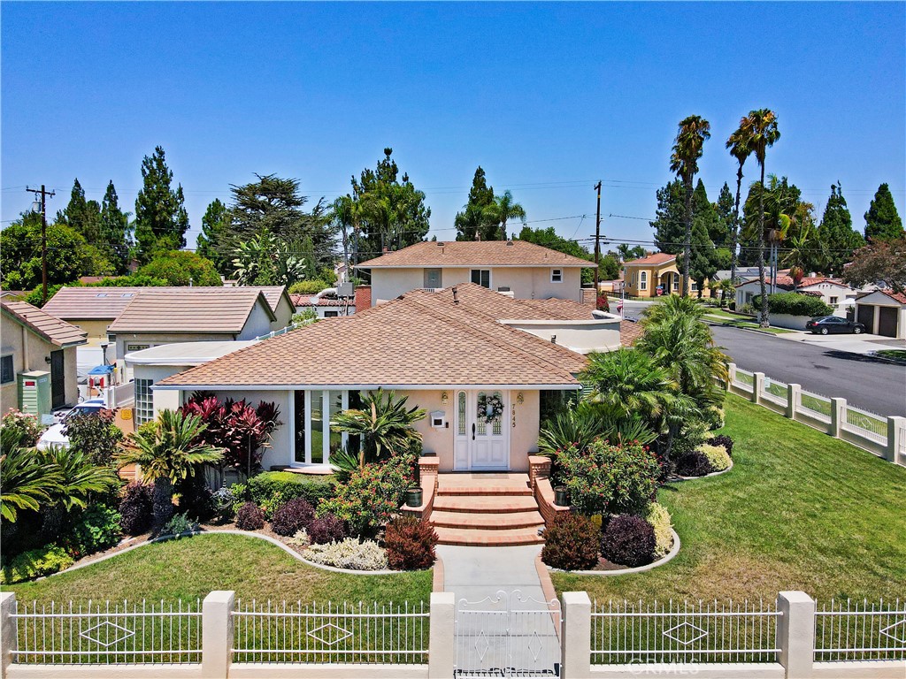 Meticulously maintained and manicured home in desirable Orange Estates. This lovely corner home is move in ready! Large formal entry opens to spacious living room with custom wet bar area. Wood shutters adorn the bay window, the ceiling has a unique design, combined with a glass brick wall and wood flooring. Formal dining room has a built-in wine area, bow window. Gourmet kitchen has built in refrigerator, microwave, and double ovens and granite counters and beautiful tile floors. Cozy family room has gas burning fireplace. Remodeled baths and spacious bedroom. One bedroom is currently used as an office with built in desk and cabinets. This home has tons of custom cabinetry and closets for optimal storage. Beautiful covered breezeway leads to outside laundry and garage. Above the 4 car garage is a spacious 1 bedroom unit with living room and kitchen which is approximately 600 sq. ft.
(photos to follow). Adjacent to the unit is a large storage area.
Manicured rear yard has synthetic grass for easy maintenance. Additional amenities include central air, and security system.
Don't miss this opportunity to make this home yours!