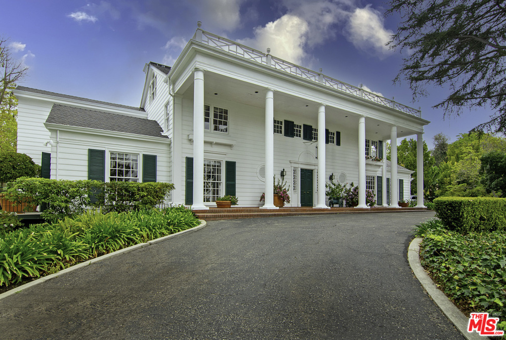 Wonderful opportunity to own one of the best homes in Lower Bel Air. First time on the market, this wooded estate sits on a 1.48 acre lot with tree top and Century City views. Lush gardens with mature trees surround this gated compound with a circular drive to motor court. A two-story entry leads to a perfect center hall plan with sweeping staircase, typical of this renowned architect. Classic living room with fireplace overlooks fountains and greenery. Large formal dining room. Open family room with bar, plus solarium with fireplace overlooks grassy yard. North/South tennis court. Other living spaces include two separate dens with fireplaces. Upstairs Master Suite plus two additional bedroom suites, one currently used as office. Also includes a downstairs bedroom suite, maids bedroom and bath near the updated kitchen. Large finished attic space, great for creative space/offices or overflow guests. All in prime Verdant Lower Bel Air.