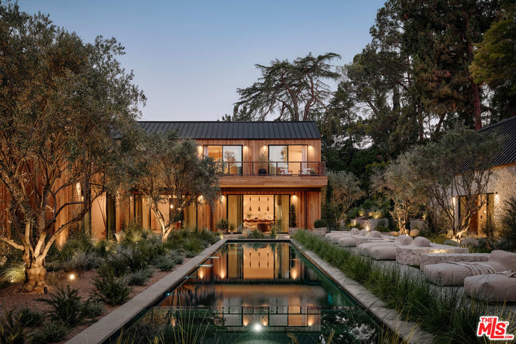 Tucked away within one of Los Angeles' most exclusive, celebrity-studded enclaves of Fryman Canyon, sits a private estate that redefines California living. Designed by AD-published visionary design firm, Studio Rob Diaz. Envisioned in the spirit of the Swedish countryside and inspired by its natural setting, lies a sculptural composition of striking A-frame volumes, cladded harmoniously in wire-brushed cedar. Monumental and inviting, the architecture harmonizes seamlessly with its serene surroundings, where century old redwoods and natural rolling hillsides create a back canvas that only this 1.4 acre estate can offer. Perfectly symmetrical in form, expansive living spaces are defined by soaring 30 foot ceilings in which custom Belgian oak floors, hand finished wall paneling, titanium travertine, copper accents and bespoke lighting, layer this home with warmth and refinement. Thoughtfully compartmentalized, the home balances intimacy with scale, offering seven bedroom suites and eleven baths across multiple forms, each designed with intention and cohesiveness. At the heart of the property is a resort-like pool, grounded by sweeping meadows and limestone decking. Flanking the rear of property are two bespoke Limestone pavilions: one dedicated to wellness with a spa, cold plunge, grand sauna and massage suite; the other a state-of-the-art fitness studio. Nestled between the pavilions, an outdoor kitchen and dining area create the ideal setting for effortless entertaining, while expansive upper decks frame breathtaking vistas of the organic landscape. From its striking architectural pedigree and bespoke materiality, to its unparalleled privacy and connection to nature, the Fryman Estate is a bold statement of design, restraint, lifestyle and legacy; crafted for those who demand the extraordinary.