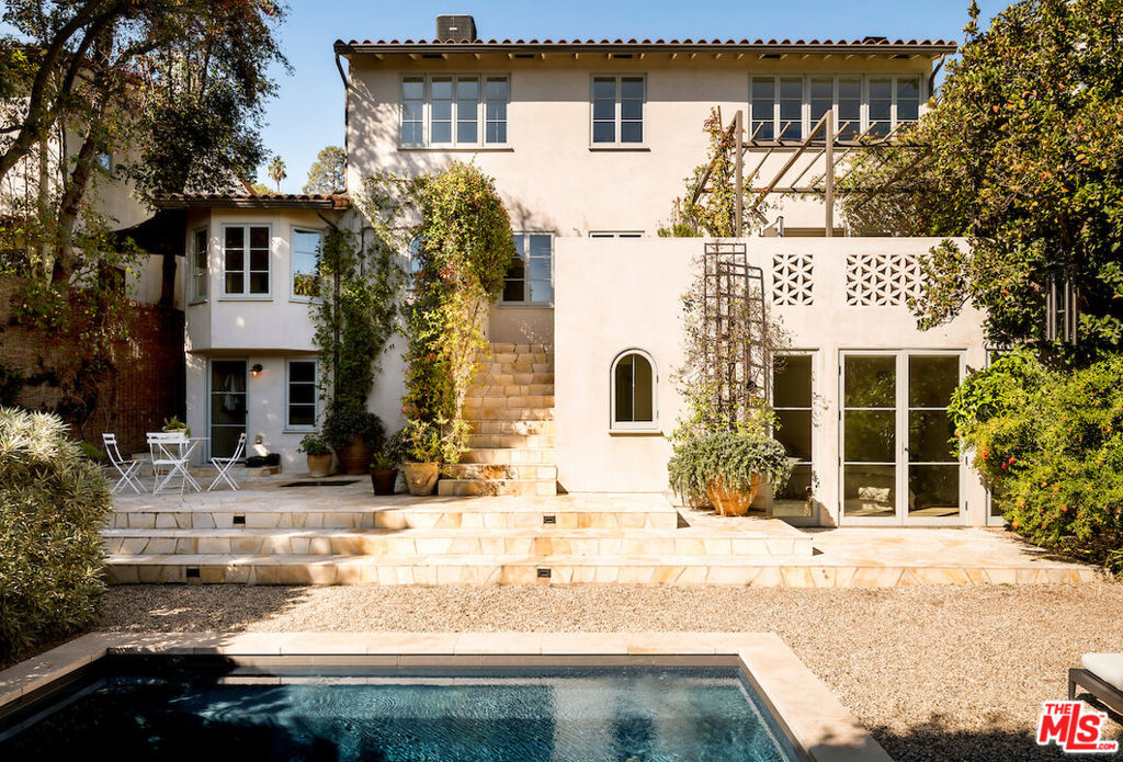 A Mediterranean Escape in Silver Lake's Moreno Highlands! Just moments from the Reservoir, this exquisitely renovated 1933 Monterey Colonial home offers 4 bedrooms and 4 bathrooms, masterfully blending modern design with timeless warmth and charm. A true private compound, the property is fully hedged and fenced for ultimate privacy. Step through the front gate and into a romantic courtyard garden with a trickling antique fountain, an enchanting secret oasis that feels worlds away, reminiscent of the South of France. Designed for effortless indoor/outdoor living, French doors from the kitchen and dining room open to the garden, while a covered second-floor balcony overlooks the serene grounds. The flat backyard is an entertainer's dream, featuring a stunning pool, patio, and fountain, perfect for dining al fresco or soaking in the sun. Inside, the home is a designer's work of art, showcasing a Bulthaup kitchen, plaster walls, vintage ironwork, California Faucets, Merit hardware, marble terrazzo, and exposed beam ceilings. Every window is custom-made by TM Cobb, complementing the high-end appliance suite that includes a Miele refrigerator and dishwasher, Wolf oven and cooktop, center island, and a coffee station that tucks away out of sight. The generous primary suite offers a luxurious retreat with vaulted ceilings, dual walk-in closets, and a breathtaking spa-like ensuite bathroom finished in marble terrazzo and tadelakt plaster. Modern comforts include solar power and a Life Source whole-home water filtration system, combining sustainability and wellness with classic architectural beauty. Ideally located in the Ivanhoe Elementary school district and moments from Silver Lake favorites like L&E Oyster Bar, Bar Siesta, La Mill Coffee, and the Silver Lake Reservoir, this property is a rare architectural gem in one of Los Angeles's most sought-after neighborhoods. Constructed with mindful craftsmanship and intention, crystals were placed throughout during renovation to promote clarity, calm, and connection, creating a sanctuary that nurtures serenity and peace.