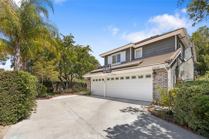 Exquisite Northbridge POOL, SPA and VIEW home on sweeping Flag Lot at the top of a tree lined cul de sac street with OWNED SOLAR! This beautifully upgraded 2 story home features 4 bedrooms and 3 full bathrooms (one on the MAIN FLOOR) plus a 3-car garage with tons of storage and epoxy coated flooring! The soaring cathedral ceilings, regal winding staircase and plethora of picture windows offers abundant natural light leaving a lasting impression upon entering this beautiful home! With neutral, wide luxury vinyl plank flooring, recessed lighting and designer finishes this Valencia home is truly move-in ready! The light and bright living room flows seamlessly into the formal dining area, highlighted by large windows and an elegant chandelier! The heart of the home is the beautifully upgraded kitchen featuring a gorgeous, quartz topped center island with bar seating, stainless steel appliances and glass cabinetry accents! The kitchen conveniently opens to the spacious and inviting family room complete with brick fireplace, wood mantle, crown molding, and ceiling fan! This main living space overlooks the sparkling swimming pool, covered patio and built-in BBQ! The main floor also boasts a huge DOWNSTAIRS BEDROOM AND BATH! Tastefully upgraded with pebble like flooring, glass accents and designer lighting! Adjacent you will find the convenient laundry room complete with utility sink and extra storage leading to the 3 car garage! The entertainer’s backyard is a true retreat with a sparkling pool and spa, cascading waterfall,  covered patio, and a stone bar top complete with built-in BBQ, refrigerator, and brick pizza oven/smoker! With no rear neighbors, this space offers exceptional privacy for gatherings and outdoor fun! Upstairs, the expansive primary suite boasts a double-sided fireplace, pool views, media niche, walk-in closet, and a spa-like bathroom with dual vanities, pedestal tub and a floor-to-ceiling glass shower! The 2 additional secondary upstairs bedrooms share a spacious hall bathroom with dual sinks, granite countertop, and tub/shower combo! Additional highlights include OWNED SOLAR, upgraded lighting, and neutral palette that lends to any style! Valencia Northbridge offers some of the best community amenities in town including pools, tennis courts, playgrounds, and paseos! A short distance to Valencia High School, The Paseo Club, Santa Clarita Trail System and Wolf Creek Brewery! This is a home you will cherish for years to come!